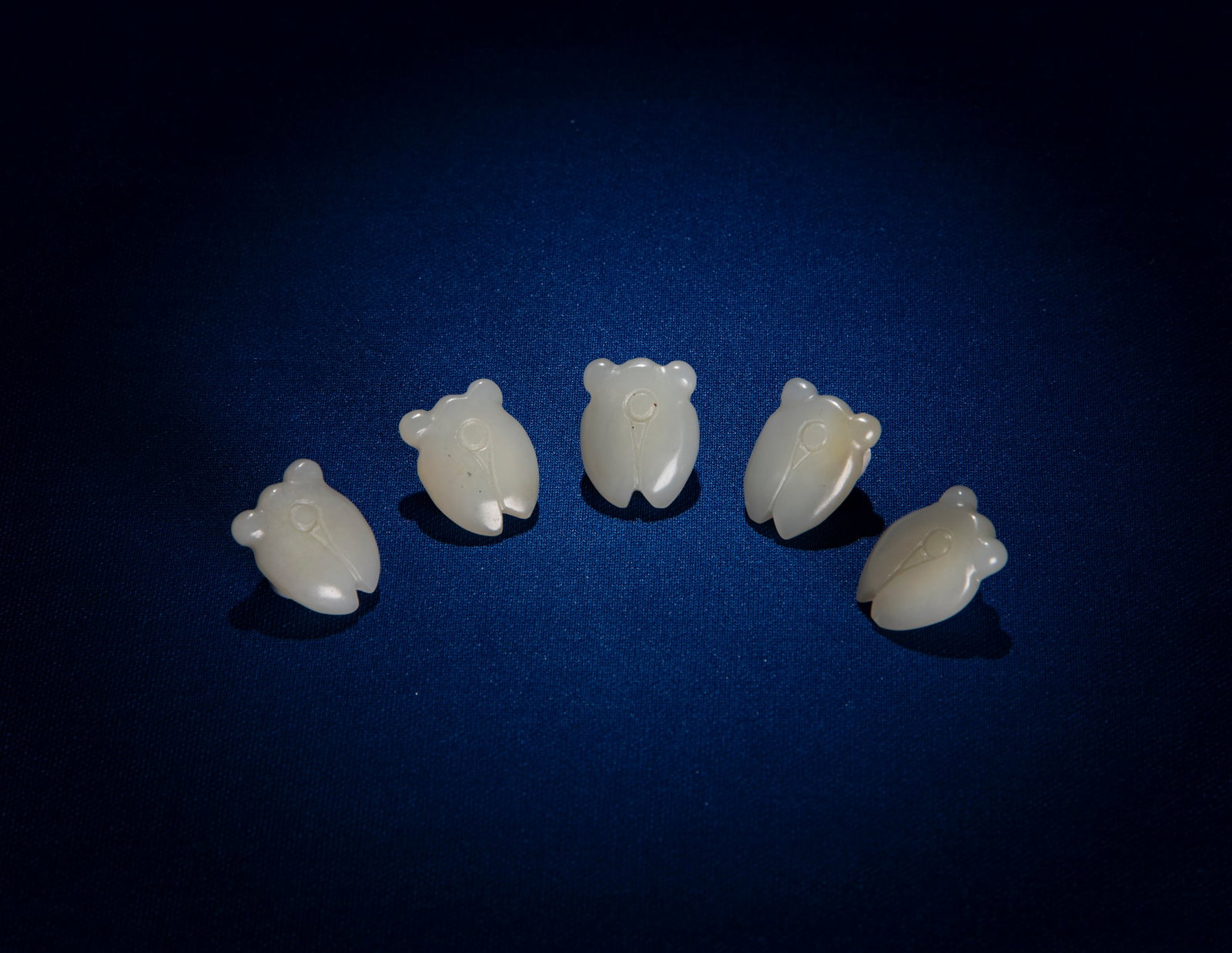 A GROUP OF FIVE CELADON JADE CICADA SHAPE BUTTONS China, Qing dynasty H.1.8cm (1 of 1)