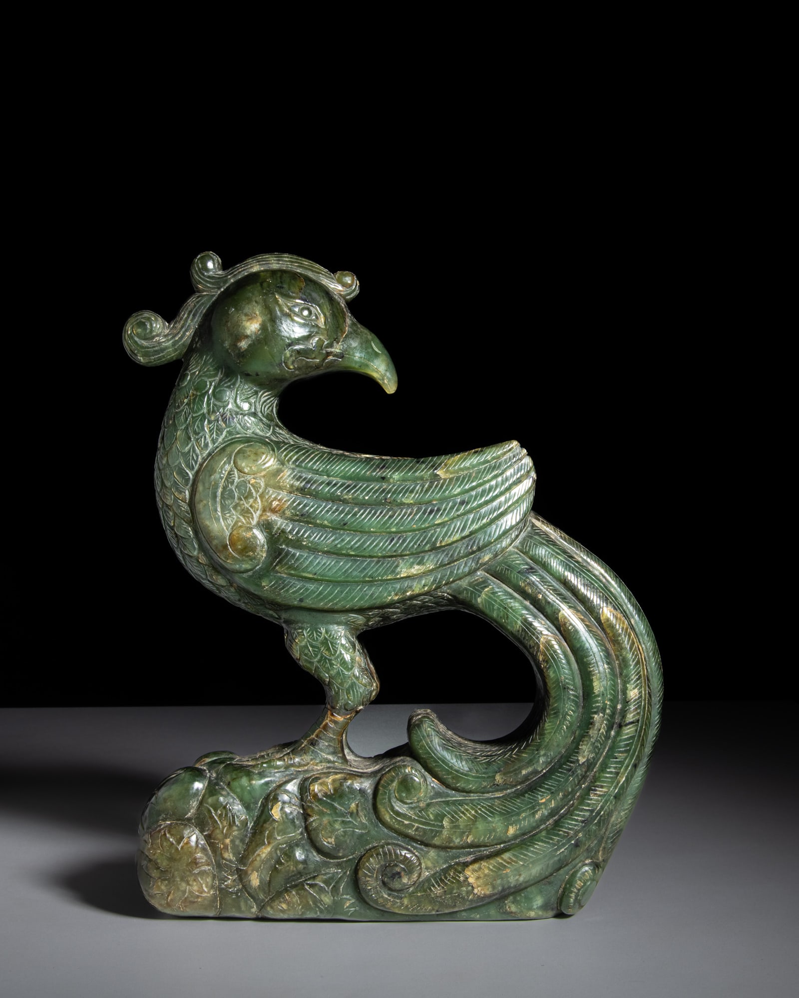 A CARVED GREEN JADE PHOENIX China, 20th century H.29.5cm (1 of 2)
