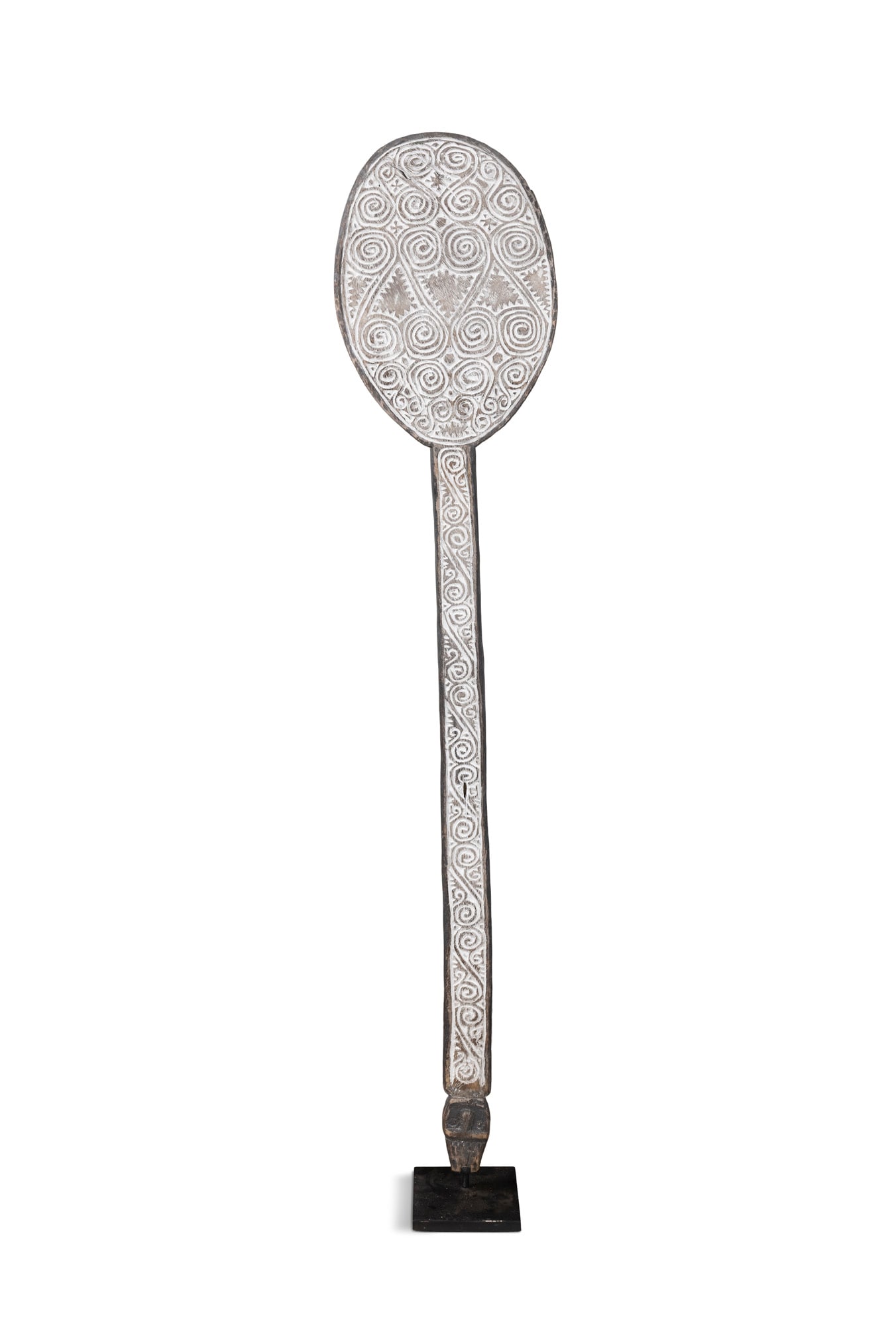 A HAND-CARVED ‘SCROLLWORK’CEREMONIAL PADDLE Indonesia, 20th century This exceptional: A HAND-CARVED ‘SCROLLWORK’CEREMONIAL PADDLE Indonesia, 20th century This exceptional hand-carved ceremonial paddle features a prominent, rounded blade transitioning into a long, slender ha