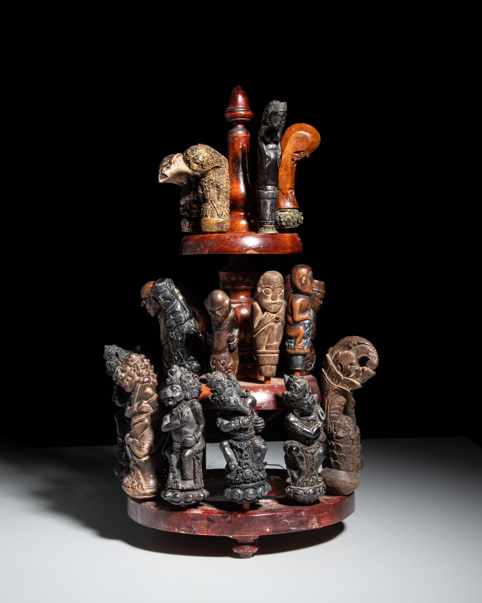 A SET OF TWENTY-TWO KRIS-HILTS Indonesia, late 19th and 20th Century Seventeen in wood, one in (1 of 4)