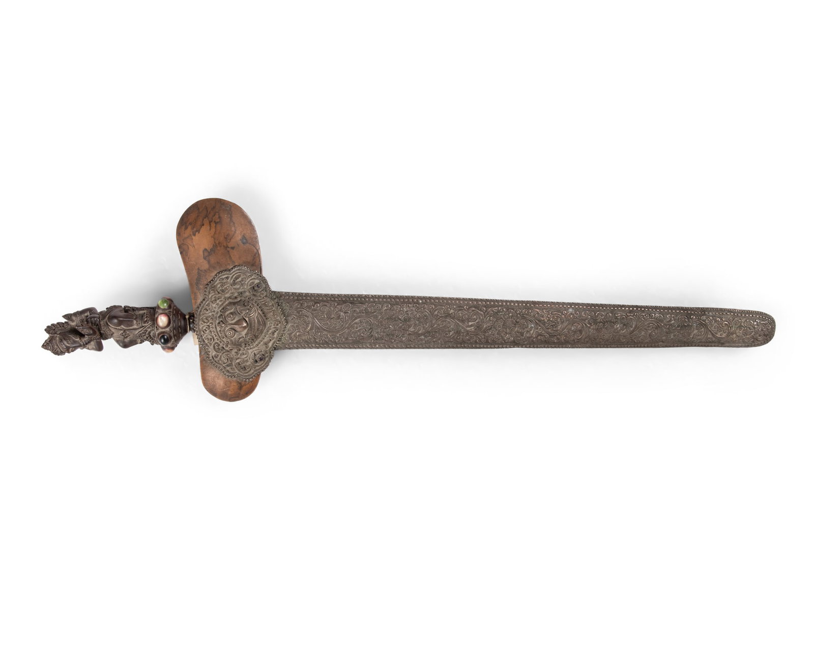 A KRIS WITH SILVERED METAL SHEATH AND WOODEN HILT WITH GANESHA Indonesia, 20th Century This kris: A KRIS WITH SILVERED METAL SHEATH AND WOODEN HILT WITH GANESHA Indonesia, 20th Century This kris features a traditionally forged wavy blade with a distinctive pamor pattern that begins with a carved l