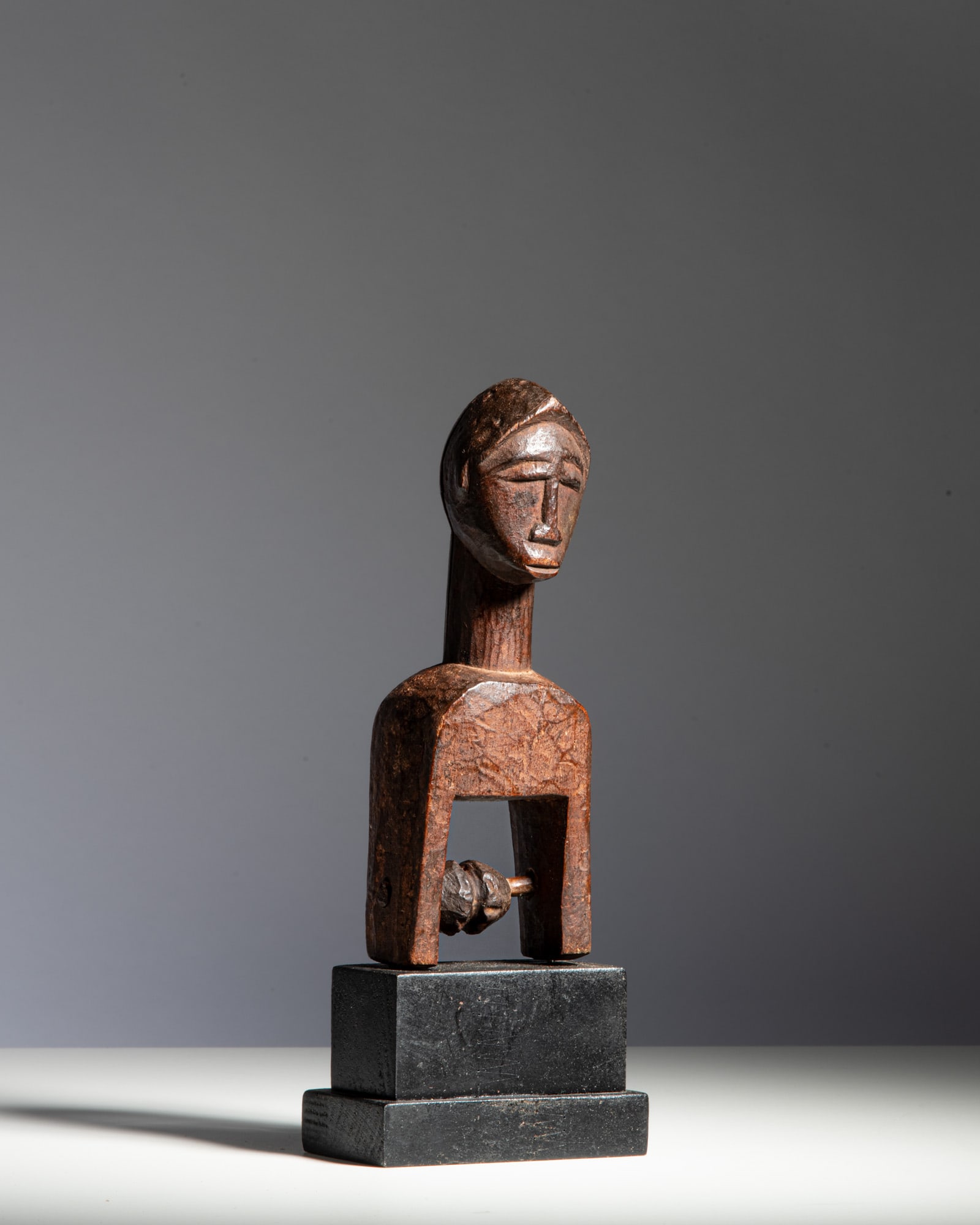 A BAULE LOOM PULLEY Ivory Coast Wood This heddle pulley features a stylized, gently tilted head (1 of 2)