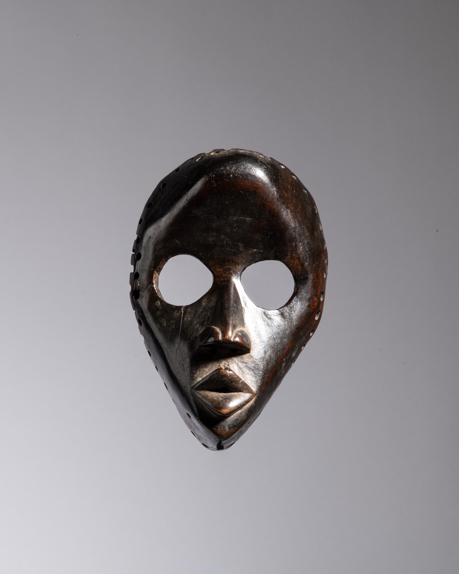 A CLASSICAL DAN CEREMONIAL MASK Dan People / Ivory Coast & Liberia Wood This refined and highly (1 of 3)