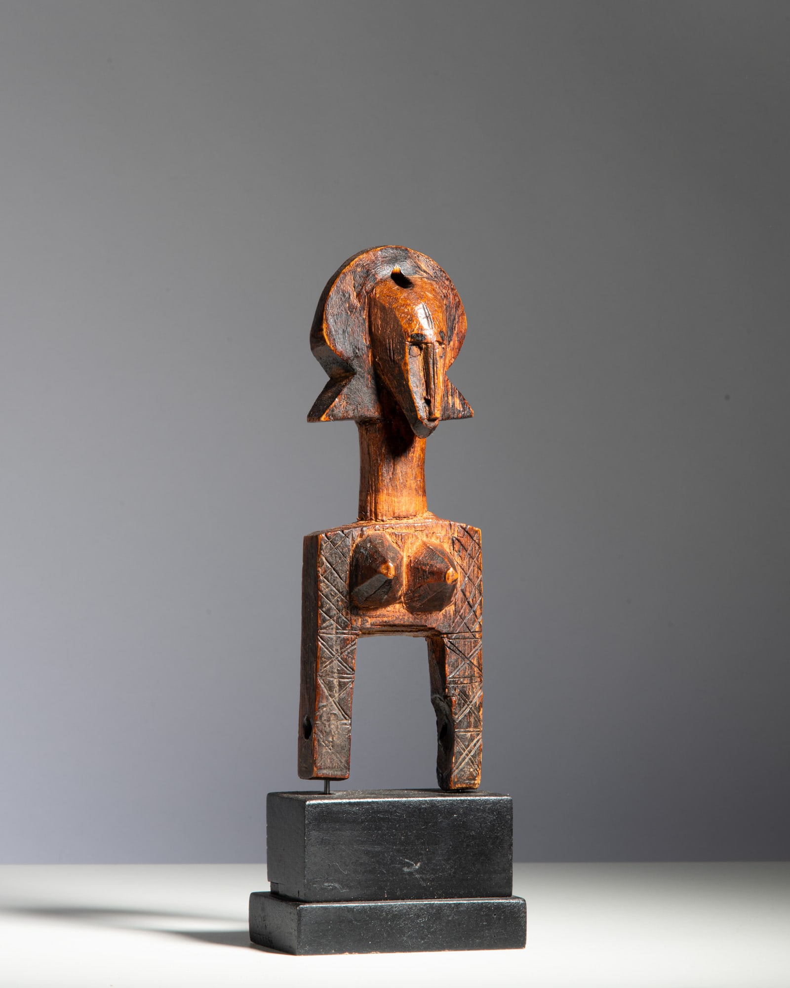 A BAMBARA LOOM PULLEY Mali Wood This fine heddle pulley features an anthropomorphic avian or: A BAMBARA LOOM PULLEY Mali Wood This fine heddle pulley features an anthropomorphic avian or antelope-inspired head, a classic motif in Bambara sculpture, characterized by a prominent beak-like nose, 