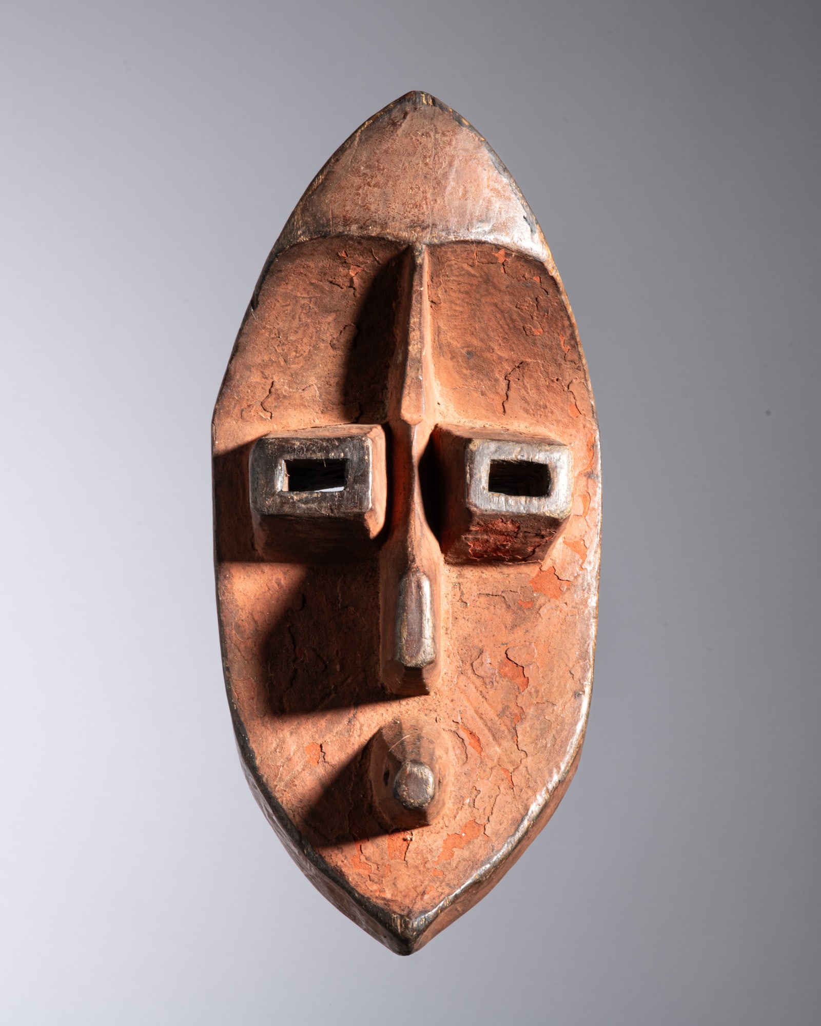 A RARE MAHONGWE CEREMONIAL MASK WITH RED PIGMENT Gabon Wood and red natural pigment This highly (1 of 3)