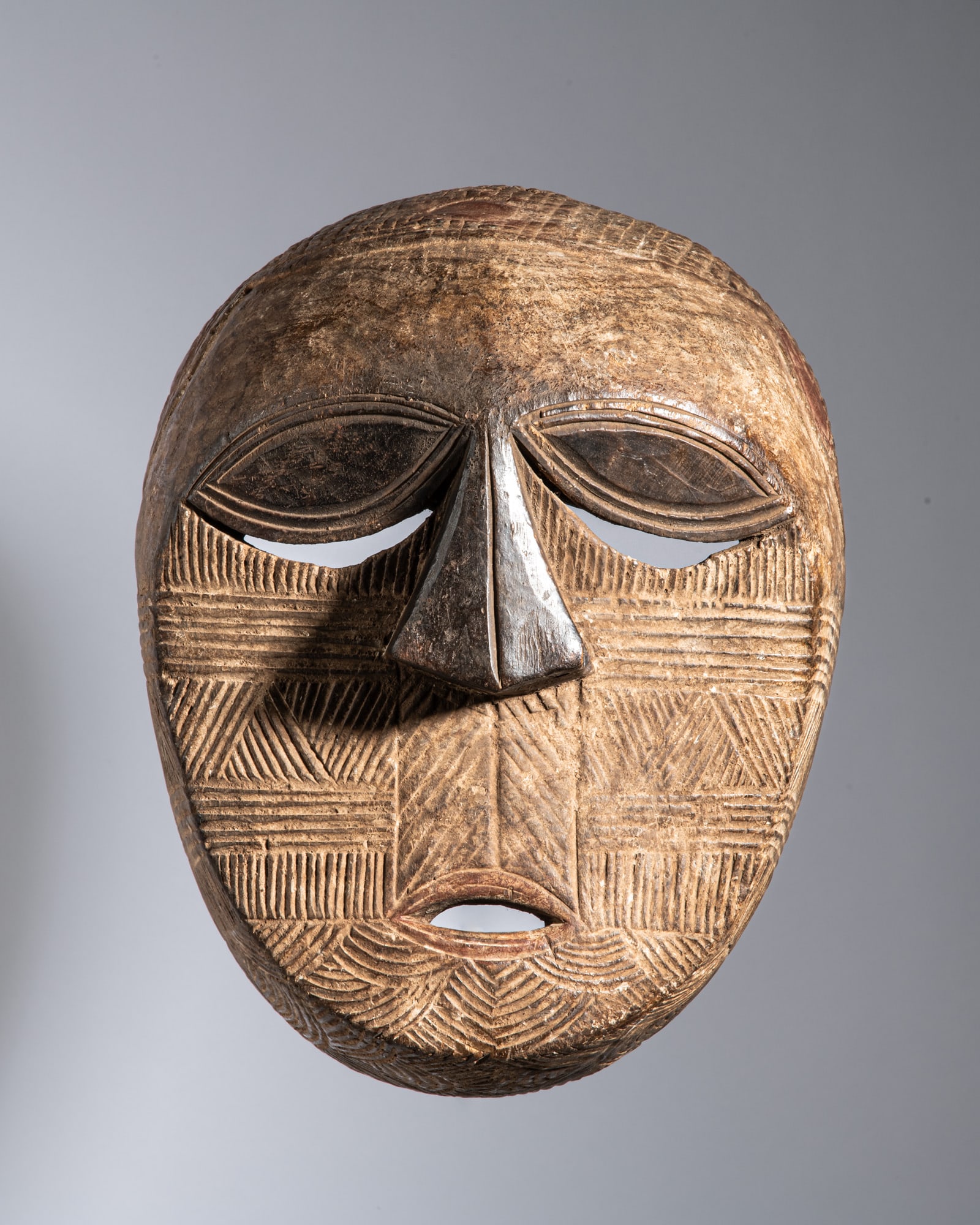 A HIGHLY INTERESTING AND DYNAMIC TETELA CEREMONIAL STRIPED MASK Democratic Republic of the Congo (1 of 3)