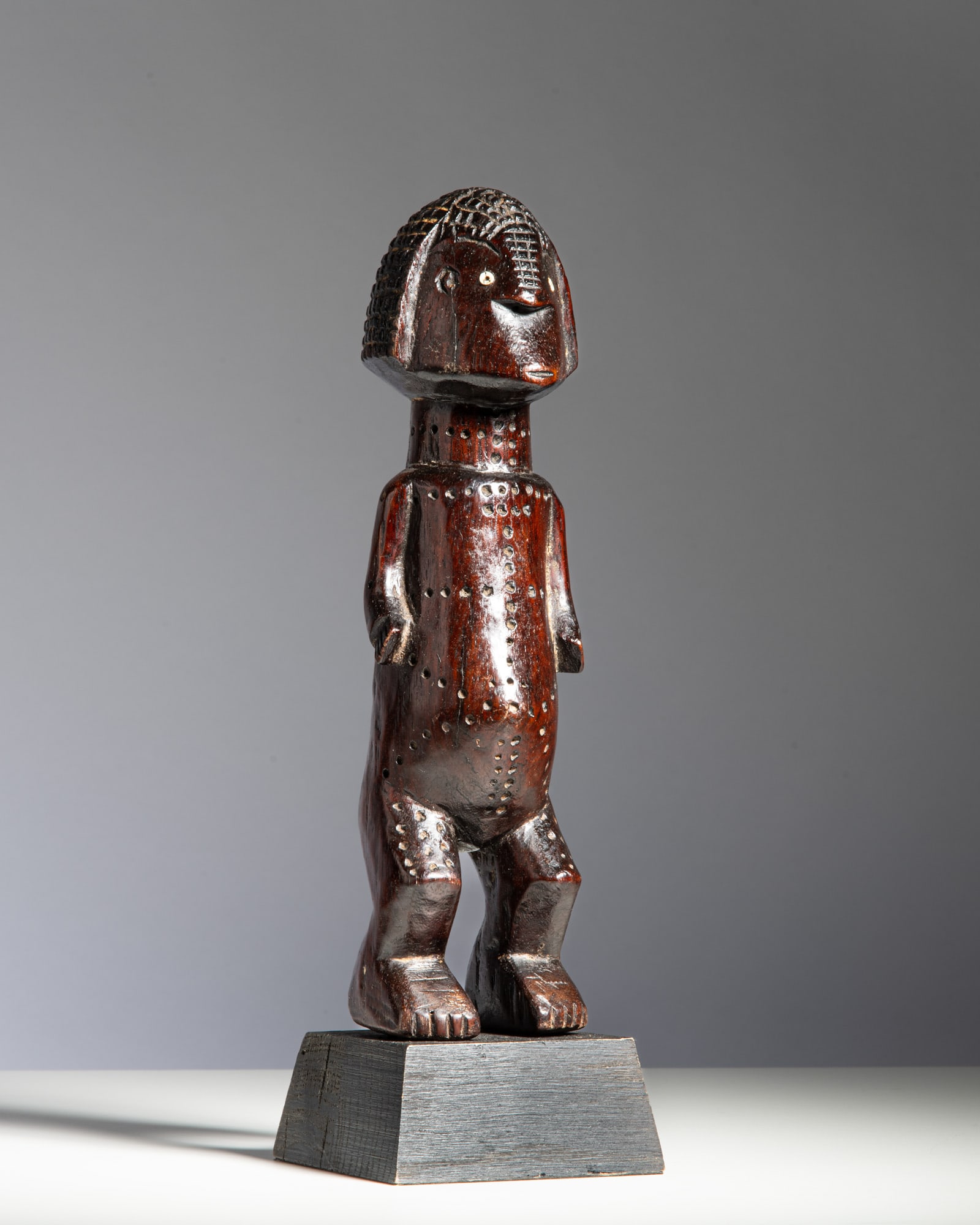 A ZANDE FIGURE Democratic Republic of the Congo Wood and brass tacks Standing on slightly (1 of 2)