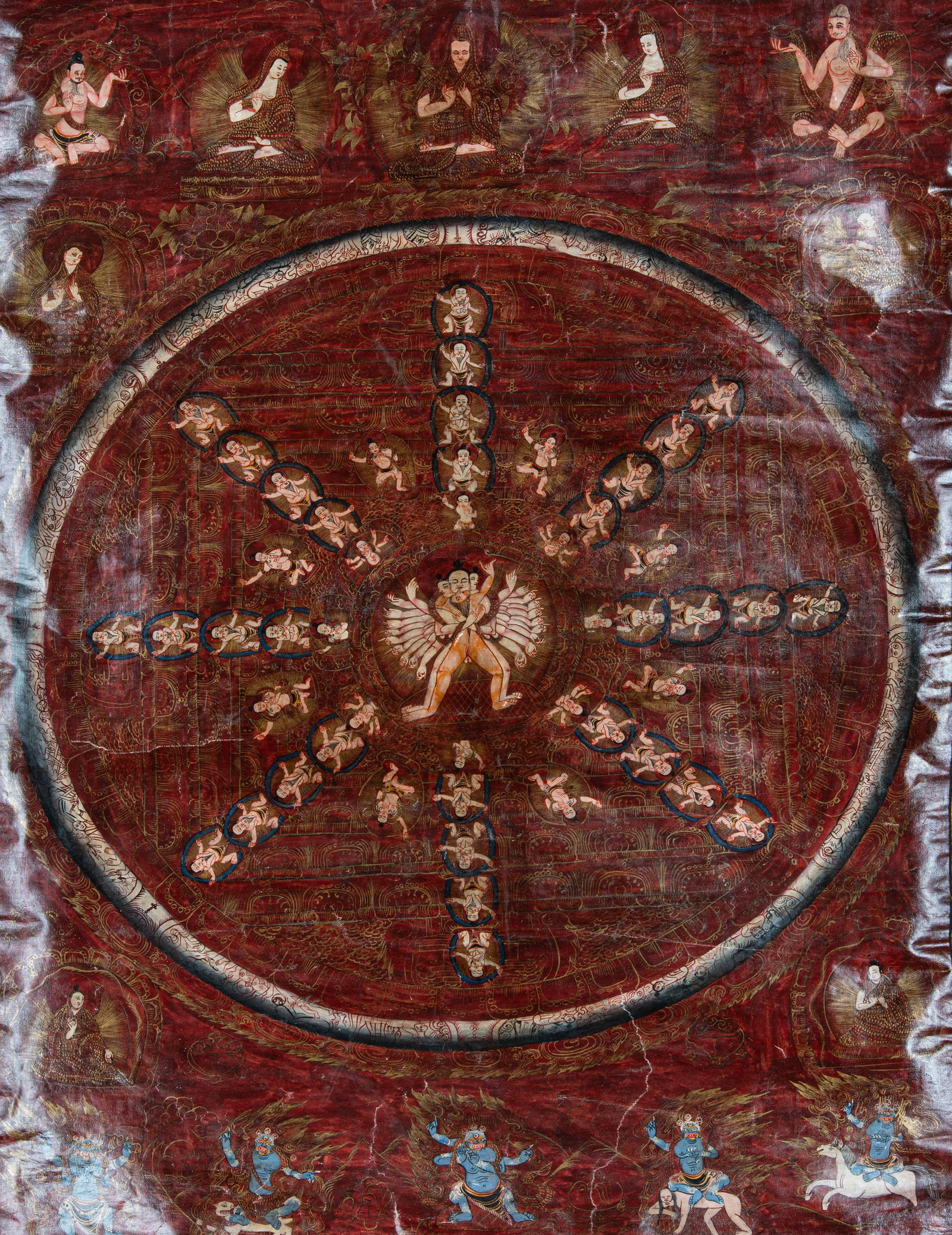 A POLYCHROME AND GILT THANGKA ON A RED GROUND DEPICTING THE MANDALA OF ÇAKRASAMVARA Nepal, 20t: A POLYCHROME AND GILT THANGKA ON A RED GROUND DEPICTING THE MANDALA OF ÇAKRASAMVARA Nepal, 20th Century. With a dark green silk brocade framing. Size. 54 x 72 cm Provenance: from the collection o