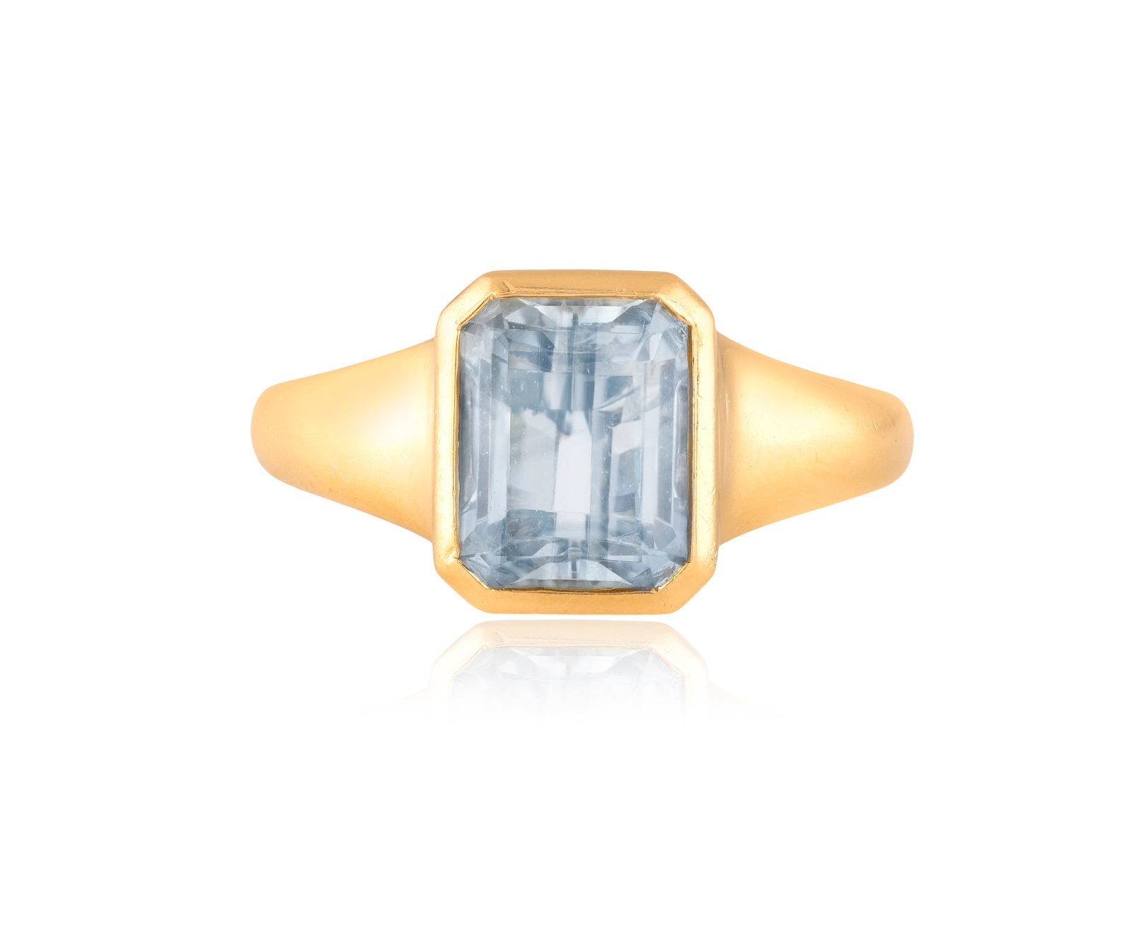 BULGARI: A TOPAZ RING Centring a rectangular blue topaz in collet-setting, to a tapered polished: BULGARI: A TOPAZ RING Centring a rectangular blue topaz in collet-setting, to a tapered polished band, mounted in 18K gold, signed Bvlgari, Italian registry mark, ring size L