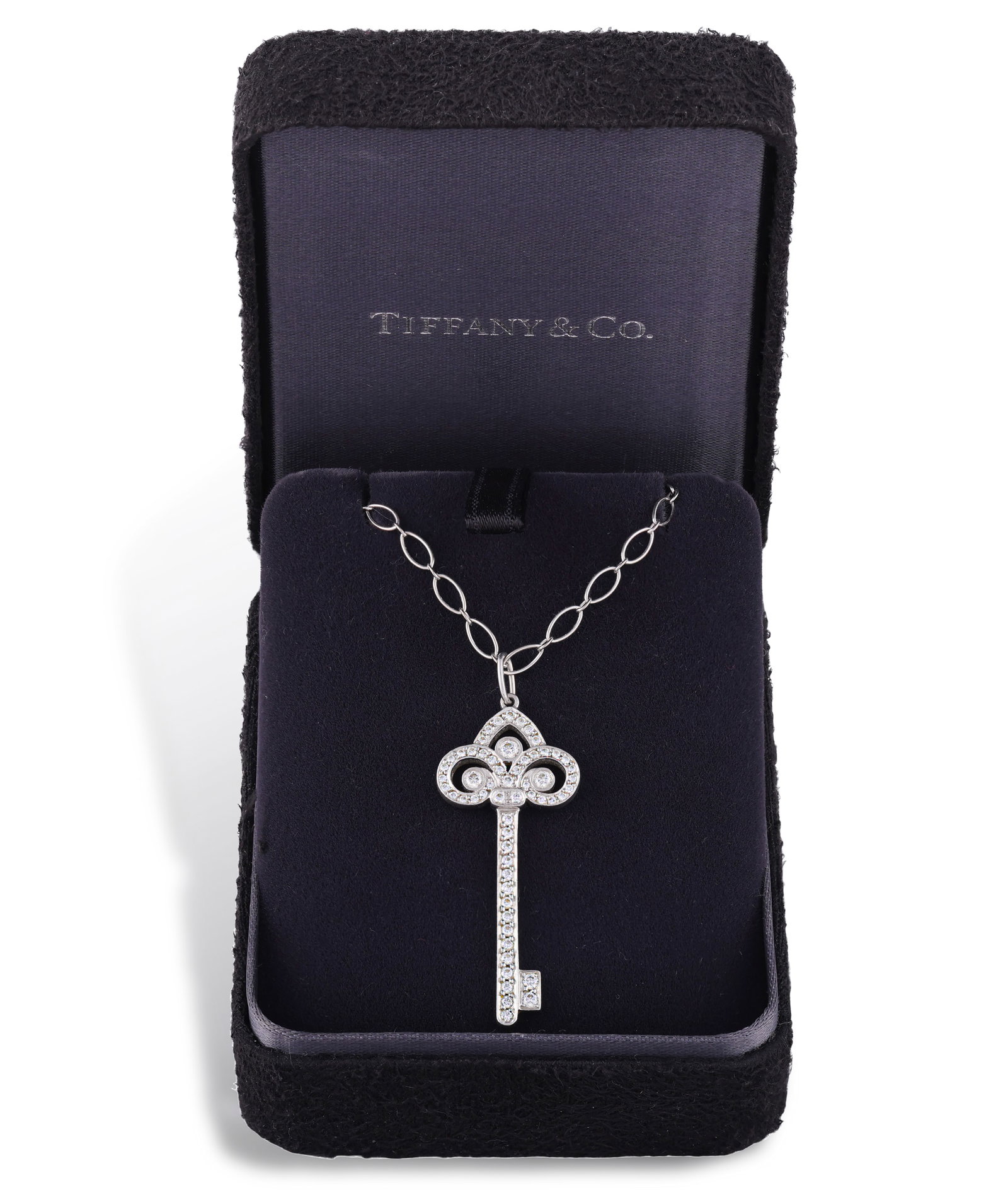 TIFFANY & CO.: A DIAMOND ‘FLEUR DE LIS KEY’ PENDANT ON CHAIN The bow designed as a (1 of 3)