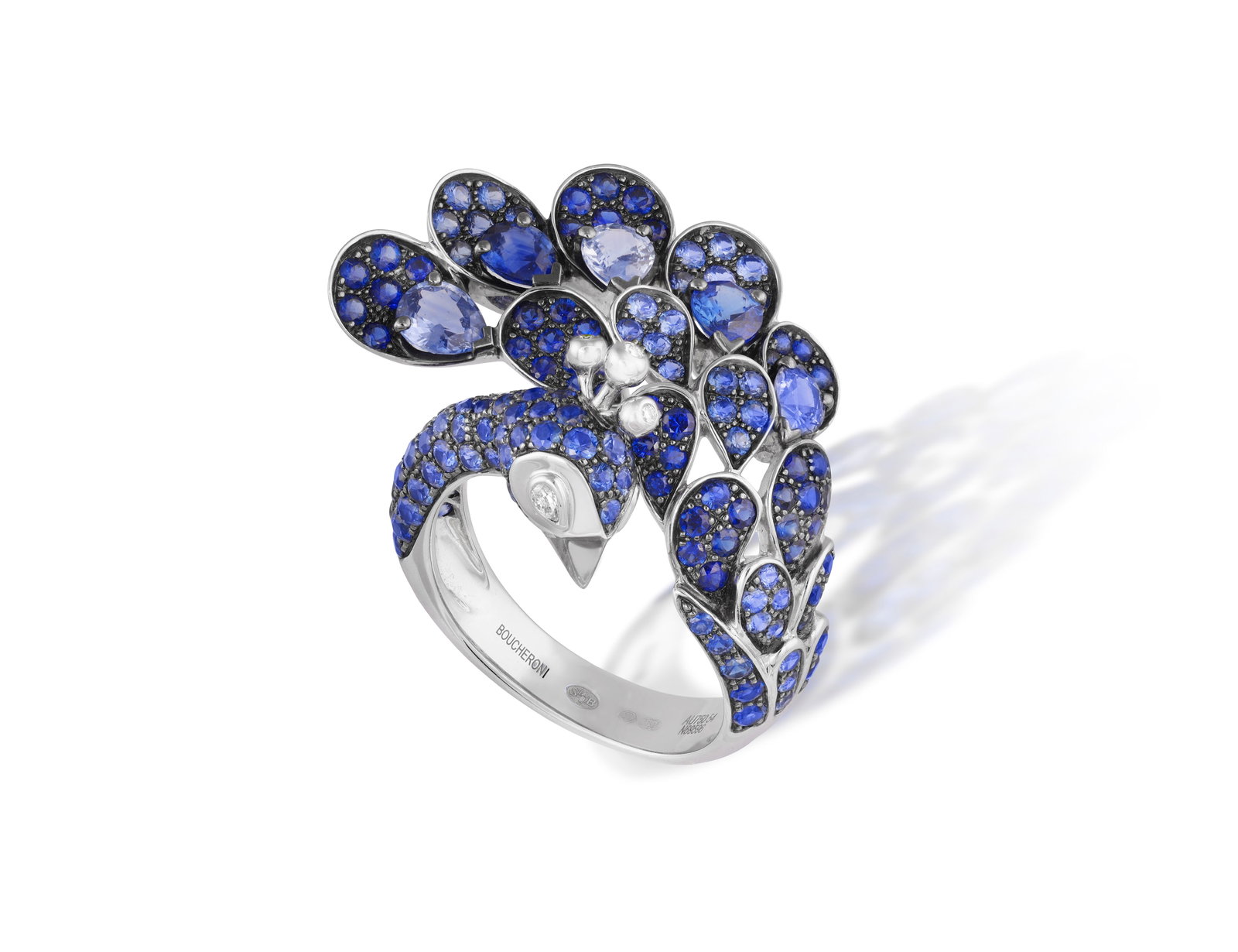 BOUCHERON: A SAPPHIRE AND DIAMOND 'HERA' RING, CIRCA 2013 Designed as a stylised peacock, set with: BOUCHERON: A SAPPHIRE AND DIAMOND 'HERA' RING, CIRCA 2013 Designed as a stylised peacock, set with circular-cut sapphires throughout and pear-shaped diamond eyes, mounted in 18K gold, signed Boucheron