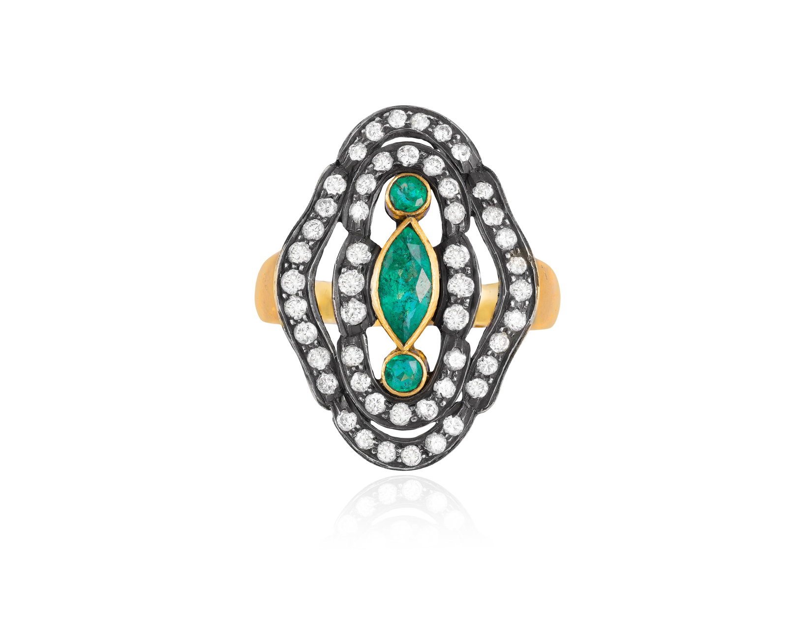 AN EMERALD AND DIAMOND DRESS RING Of openwork design, the navette-shaped mount centring a marquise: AN EMERALD AND DIAMOND DRESS RING Of openwork design, the navette-shaped mount centring a marquise and circular-cut emeralds within collet-setting, to old single-cut diamond surrounds, mounted in silv