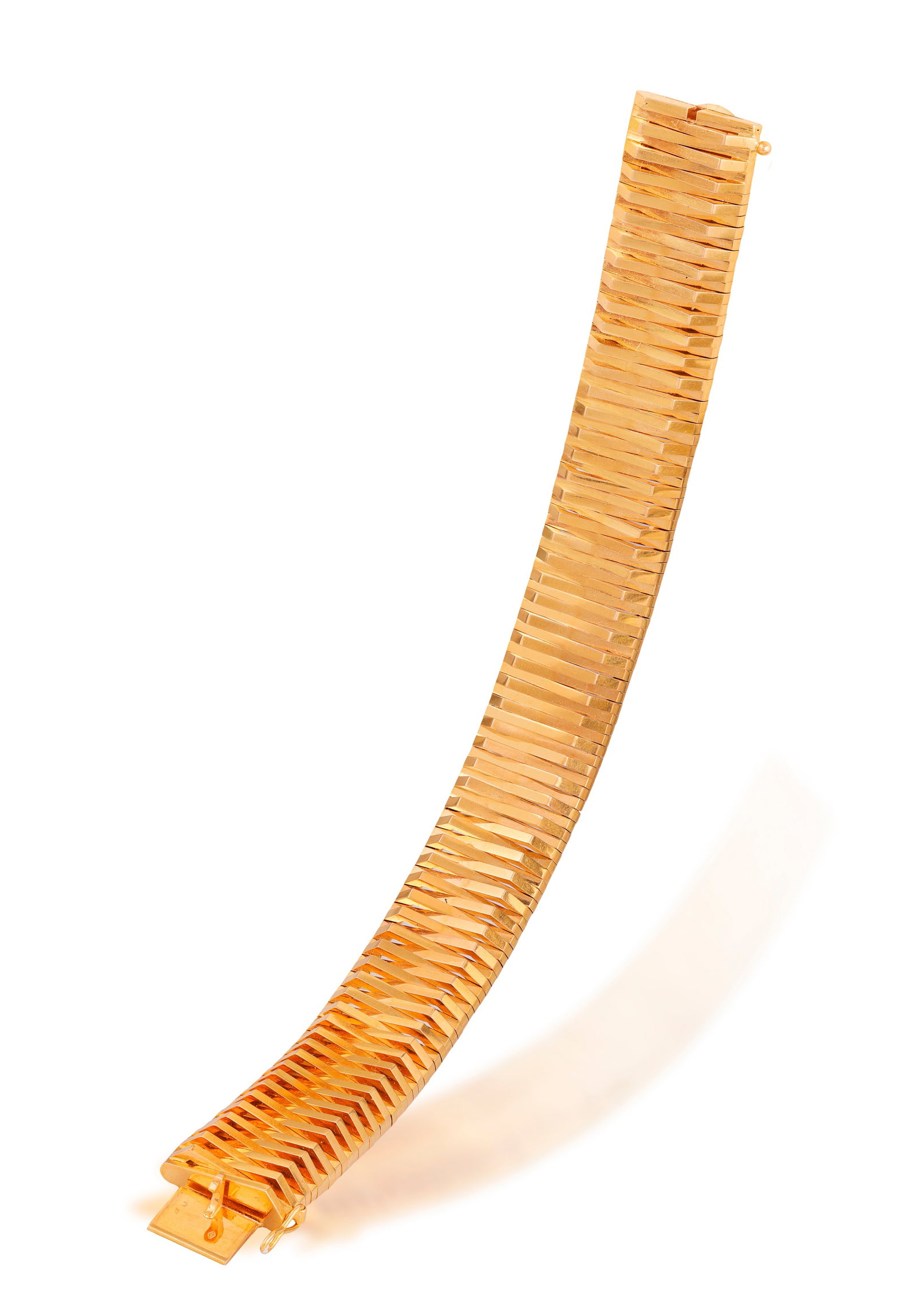 A RETRO GOLD BRACELET, FRENCH, CIRCA 1950 Designed as a series of fancy-links arranged in a chevron: A RETRO GOLD BRACELET, FRENCH, CIRCA 1950 Designed as a series of fancy-links arranged in a chevron pattern, in 18K gold, with partial maker's mark, French assay marks, length 18.6cm
