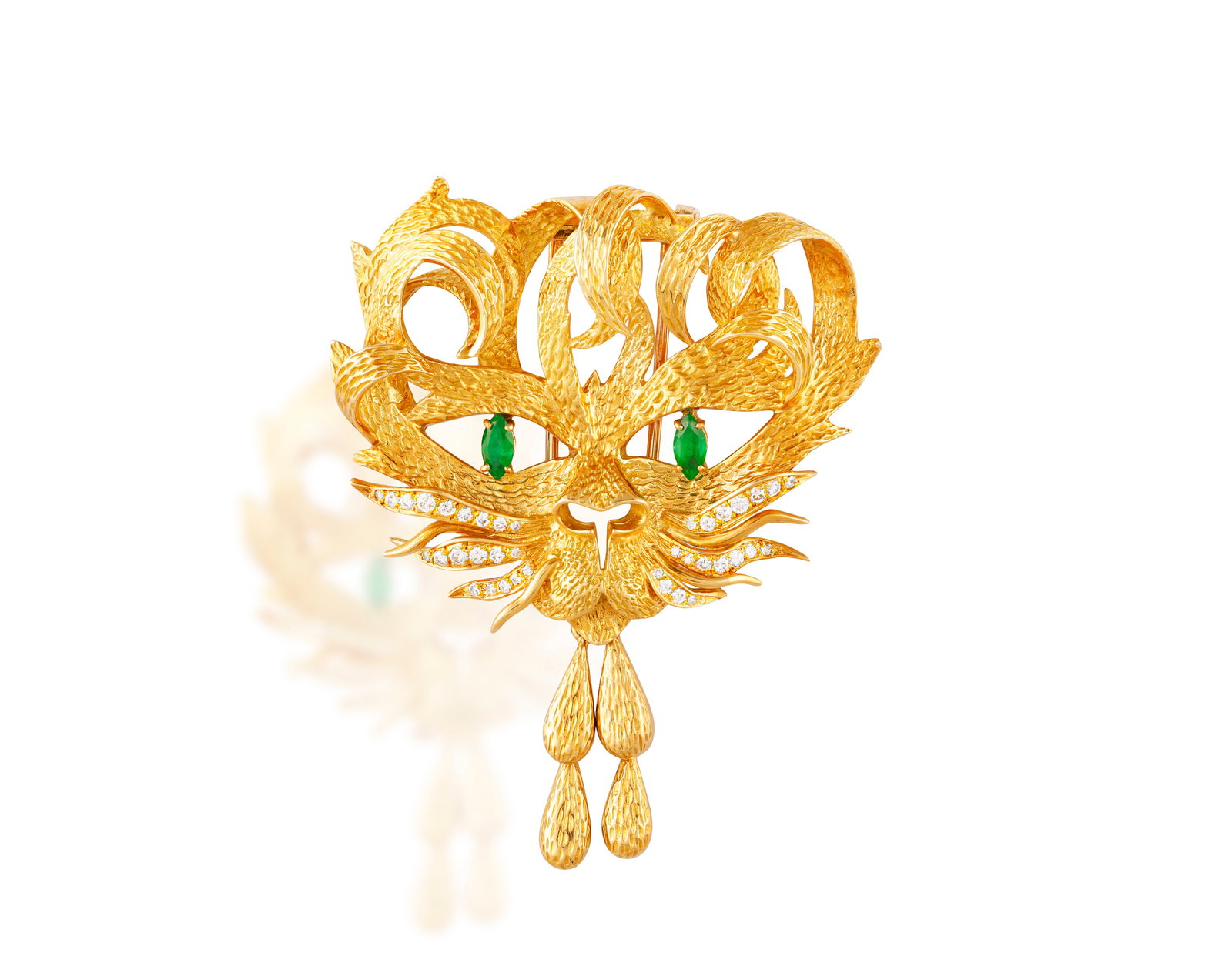 HERMÈS: A DIAMOND AND EMERALD 'MISTIGRI' BROOCH, CIRCA 1965 Designed after a drawing by Jean: HERMÈS: A DIAMOND AND EMERALD 'MISTIGRI' BROOCH, CIRCA 1965 Designed after a drawing by Jean Cocteau The textured gold cat's head with brilliant-cut diamond whiskers and marquise-shaped emerald e