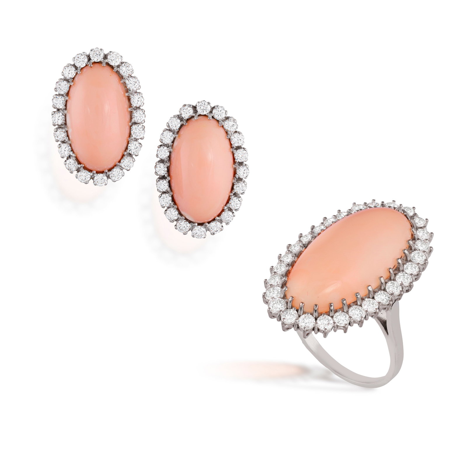 G. NARDI: A PAIR OF CORAL AND DIAMOND EARCLIPS WITH RING EN SUITE, CIRCA 1965 Each elongated: G. NARDI: A PAIR OF CORAL AND DIAMOND EARCLIPS WITH RING EN SUITE, CIRCA 1965 Each elongated oval-shaped coral cabochon, within multiple claw-setting and a brilliant-cut diamond frame, mounted in 18K 