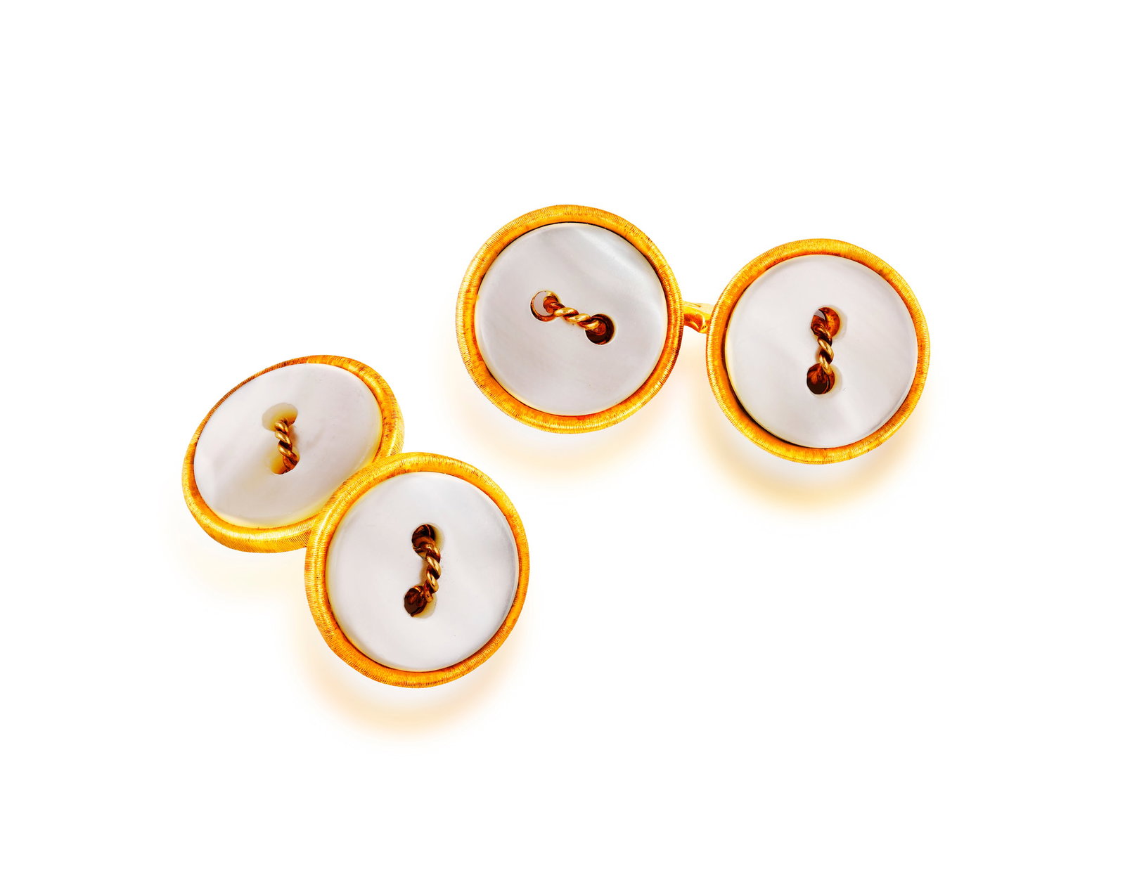 FEDERICO BUCCELLATI: A PAIR OF MOTHER-OF-PEARL CUFFLINKS Of shirt button design, each pierced: FEDERICO BUCCELLATI: A PAIR OF MOTHER-OF-PEARL CUFFLINKS Of shirt button design, each pierced circular mother-of-pearl disks with ropetwist stitch detailing at the centre and within textured gold bord