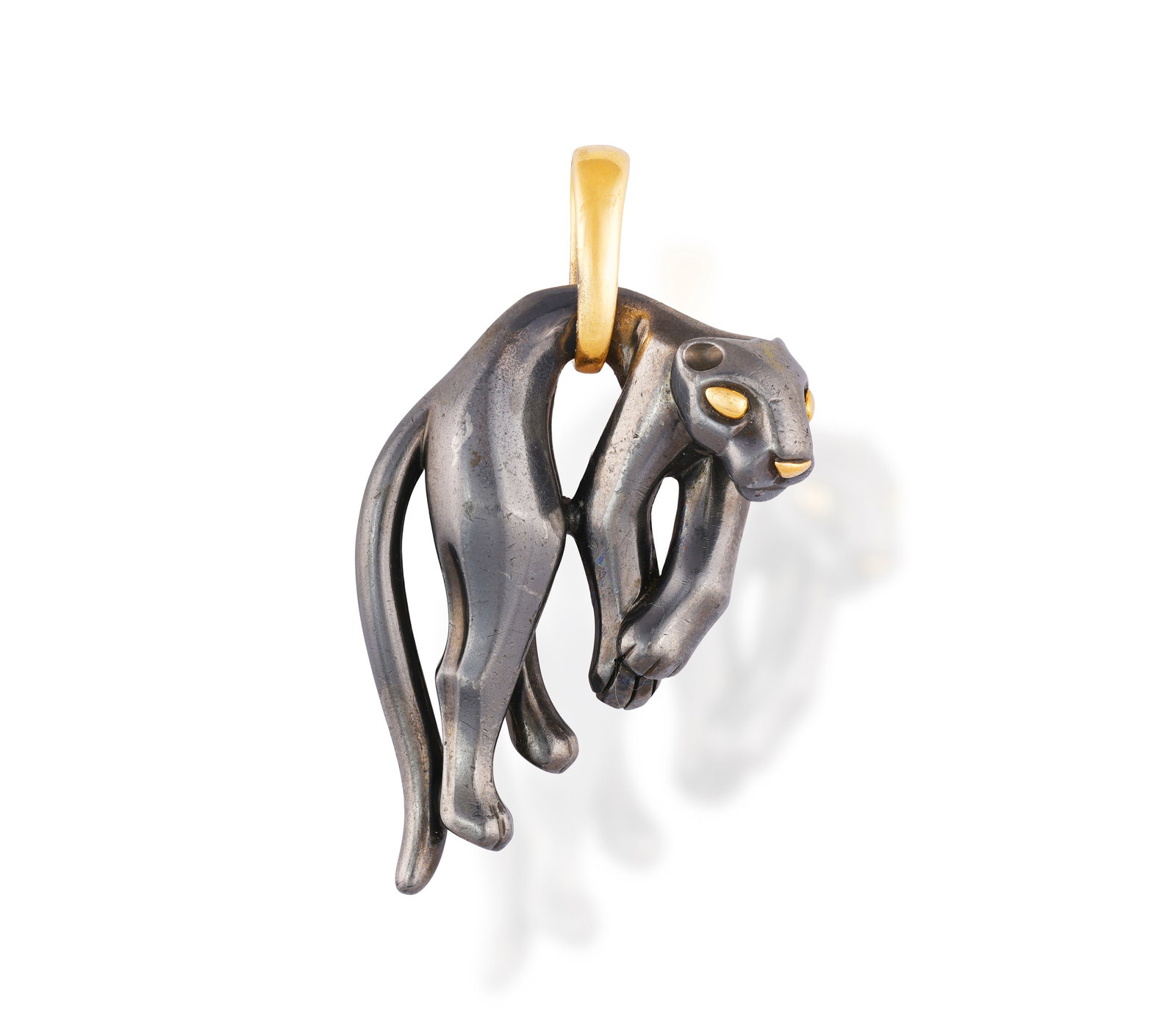 CARTIER: A 'PANTHÈRE' PENDANT, CIRCA 1990 The blackened panther with gold eyes and nose, (1 of 3)