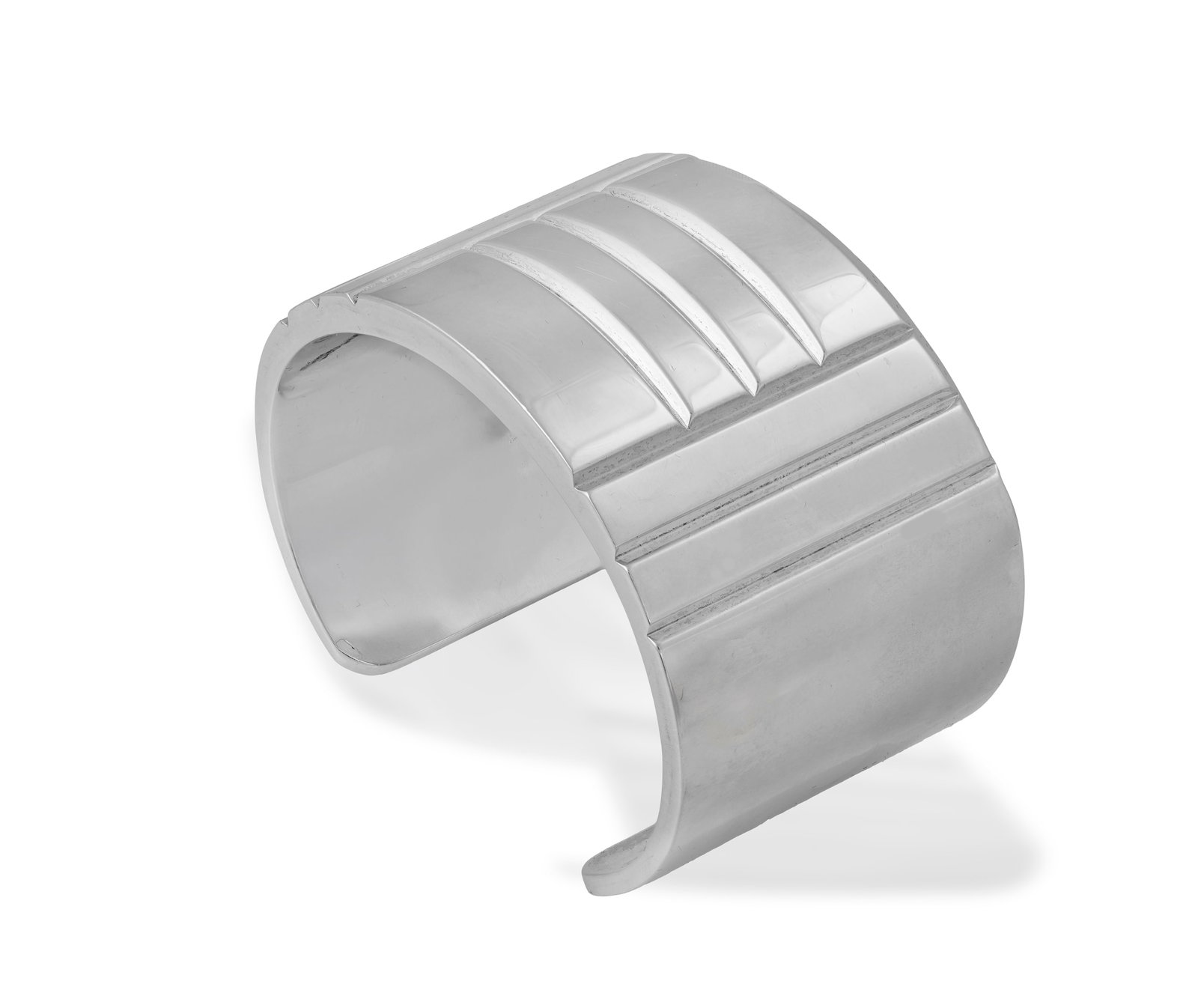 HERMÈS: A SILVER 'KELLY LOCK' CUFF BANGLE, CIRCA 2010 Of wide curved form, the polished: HERMÈS: A SILVER 'KELLY LOCK' CUFF BANGLE, CIRCA 2010 Of wide curved form, the polished surface designed with a series of reeded horizontal channels between vertical similar channels, to an open 