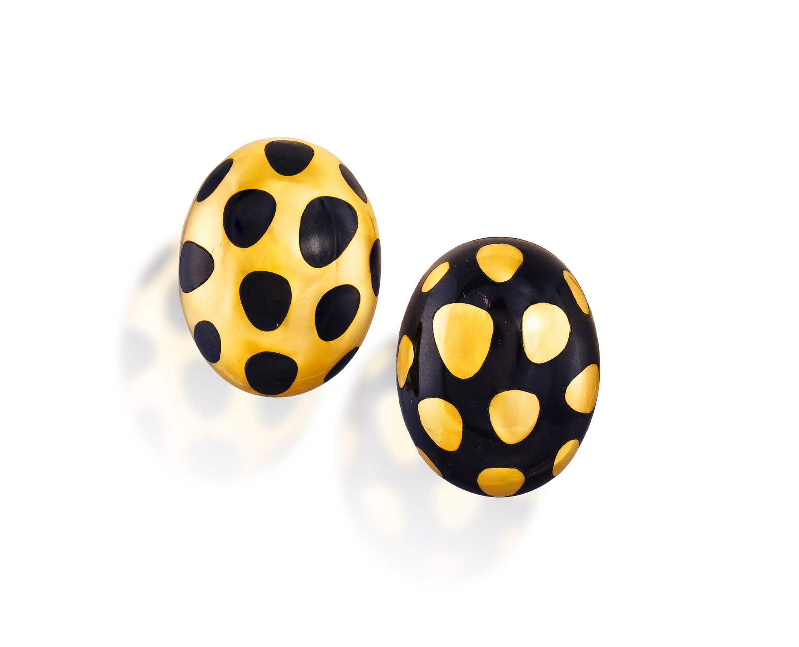 TIFFANY & CO. DESIGNED BY ANGELA CUMMINGS: A COLLECTABLE PAIR OF GOLD AND BLACK JADE 'POSITIVE: TIFFANY & CO. DESIGNED BY ANGELA CUMMINGS: A COLLECTABLE PAIR OF GOLD AND BLACK JADE 'POSITIVE NEGATIVE' EARCLIPS, CIRCA 1980 Of oval bombé design, with inlaid black jade and gold spots, mounted 