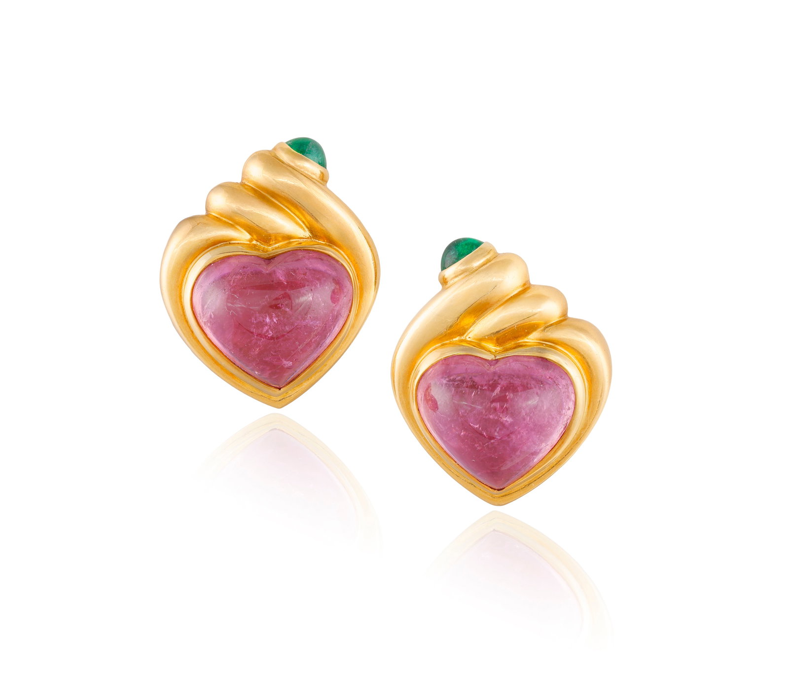 BULGARI: A PAIR OF TOURMALINE AND EMERALD EARCLIPS, CIRCA 1985 Each designed as a heart-shaped pink: BULGARI: A PAIR OF TOURMALINE AND EMERALD EARCLIPS, CIRCA 1985 Each designed as a heart-shaped pink tourmaline cabochon, within a fluted polished gold heart-shaped surround, to a circular-cut emerald 