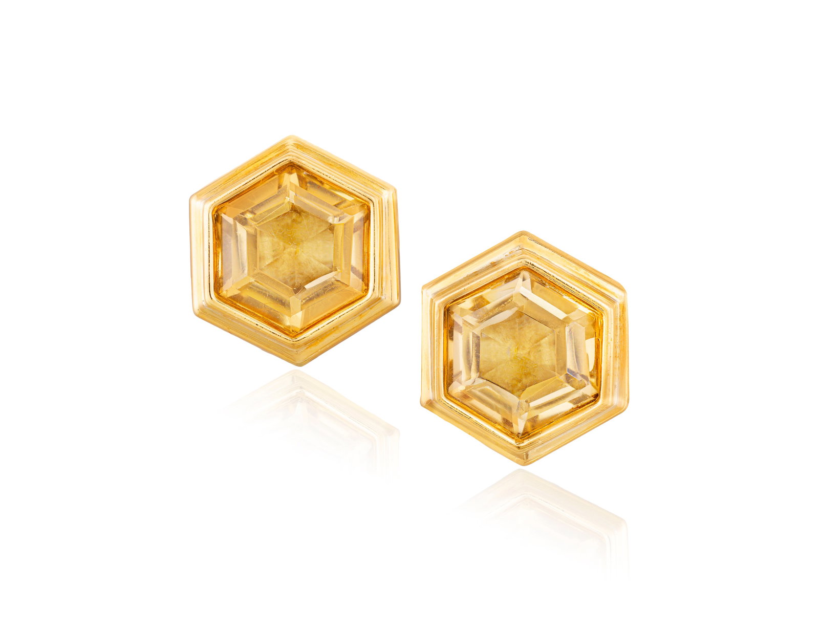 BULGARI: A PAIR OF CITRINE EARRINGS, CIRCA 1990 Each hexagon-shaped citrine set within: BULGARI: A PAIR OF CITRINE EARRINGS, CIRCA 1990 Each hexagon-shaped citrine set within collet-setting and reeded frame, mounted in 18K gold, signed Bvlgari, Italian registry mark *150ROMA, length 2cm