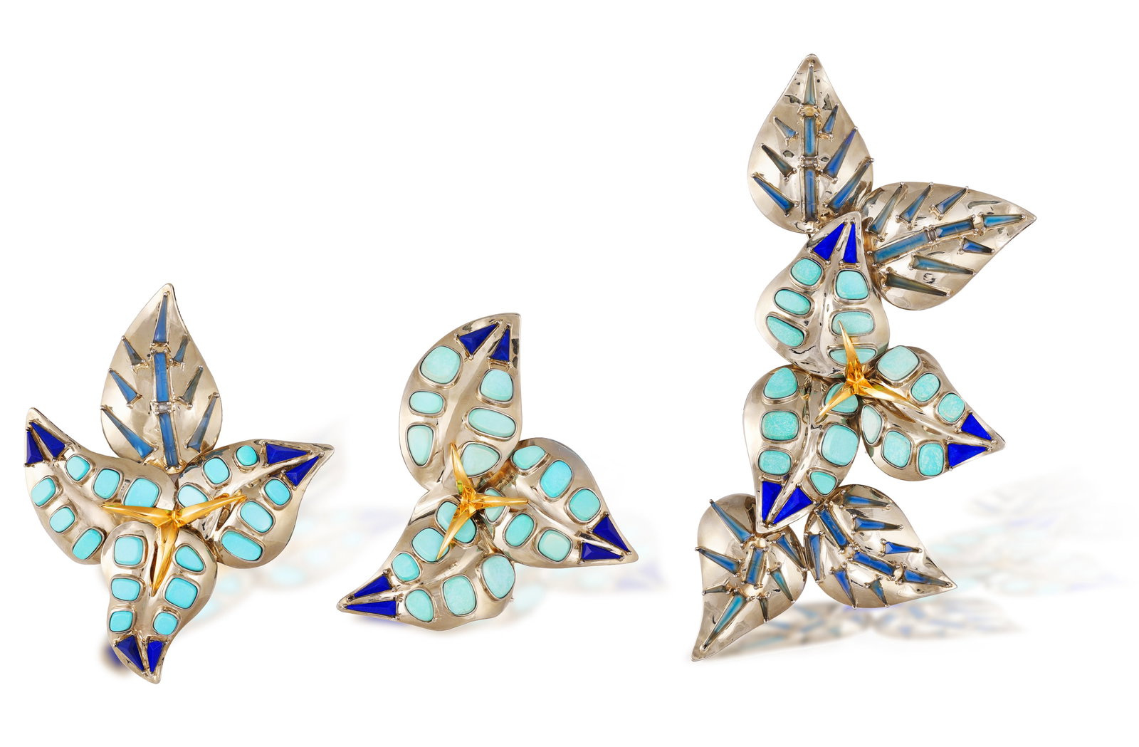 REPOSSI: AN IMPORTANT MATCHED SUITE OF LAPIS LAZULI, BLUE AGATE AND TURQUOISE JEWELLERY, 'LA: REPOSSI: AN IMPORTANT MATCHED SUITE OF LAPIS LAZULI, BLUE AGATE AND TURQUOISE JEWELLERY, 'LA BOUGAINVILLIER BLEUE' COMMISSIONED FROM REPOSSI, 1992 Comprising three graduated brooches, each modelled as