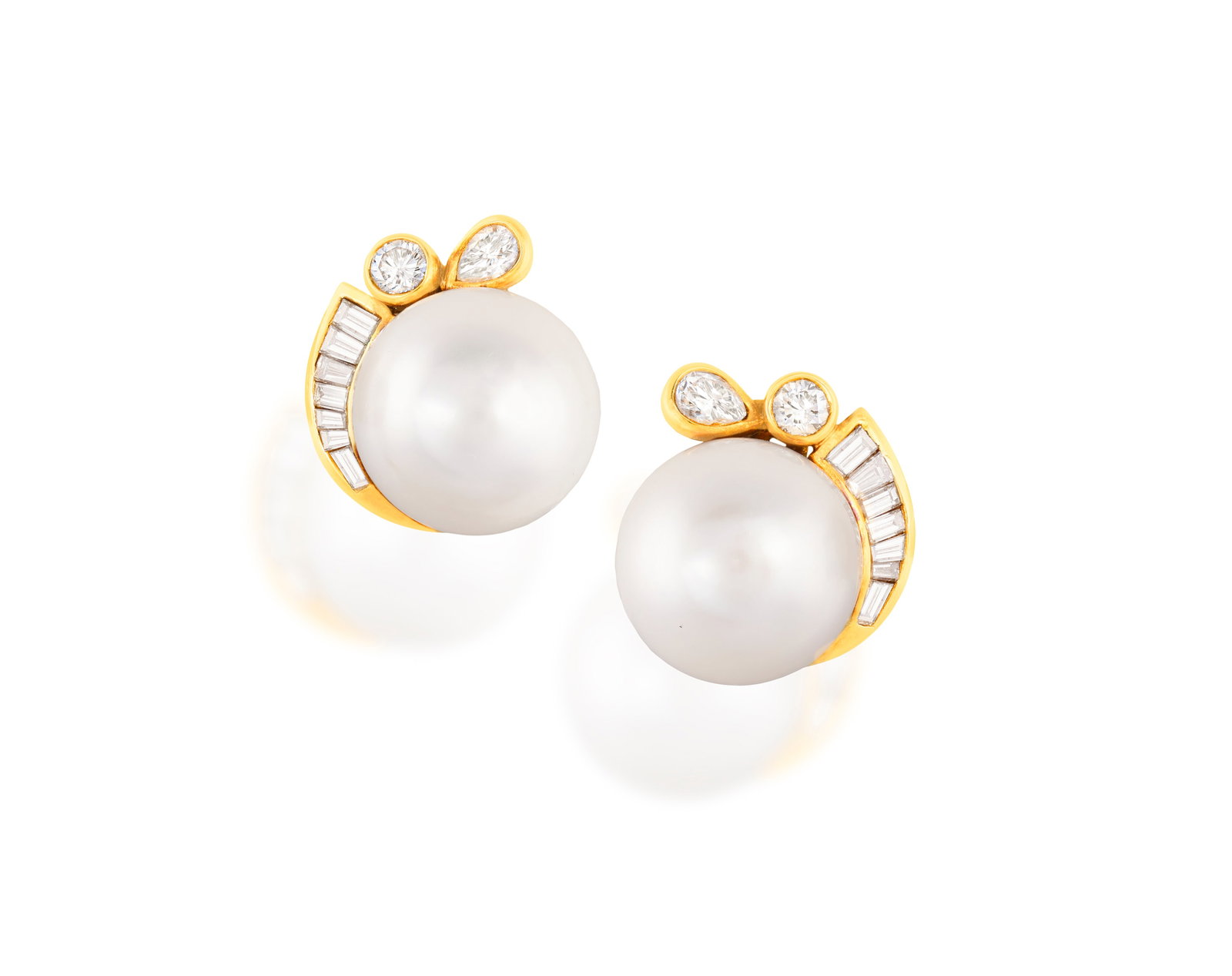 A PAIR OF CULTURED PEARL AND DIAMOND EARCLIPS Each set with a slightly button-shaped cultured pearl (1 of 3)