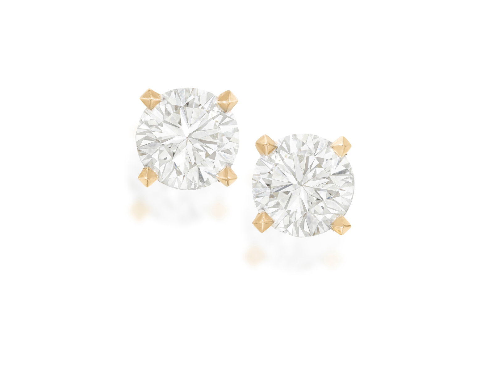 A PAIR OF DIAMOND EARSTUDS Each brilliant-cut diamond within a four-claw setting, mounted in 18K (1 of 2)
