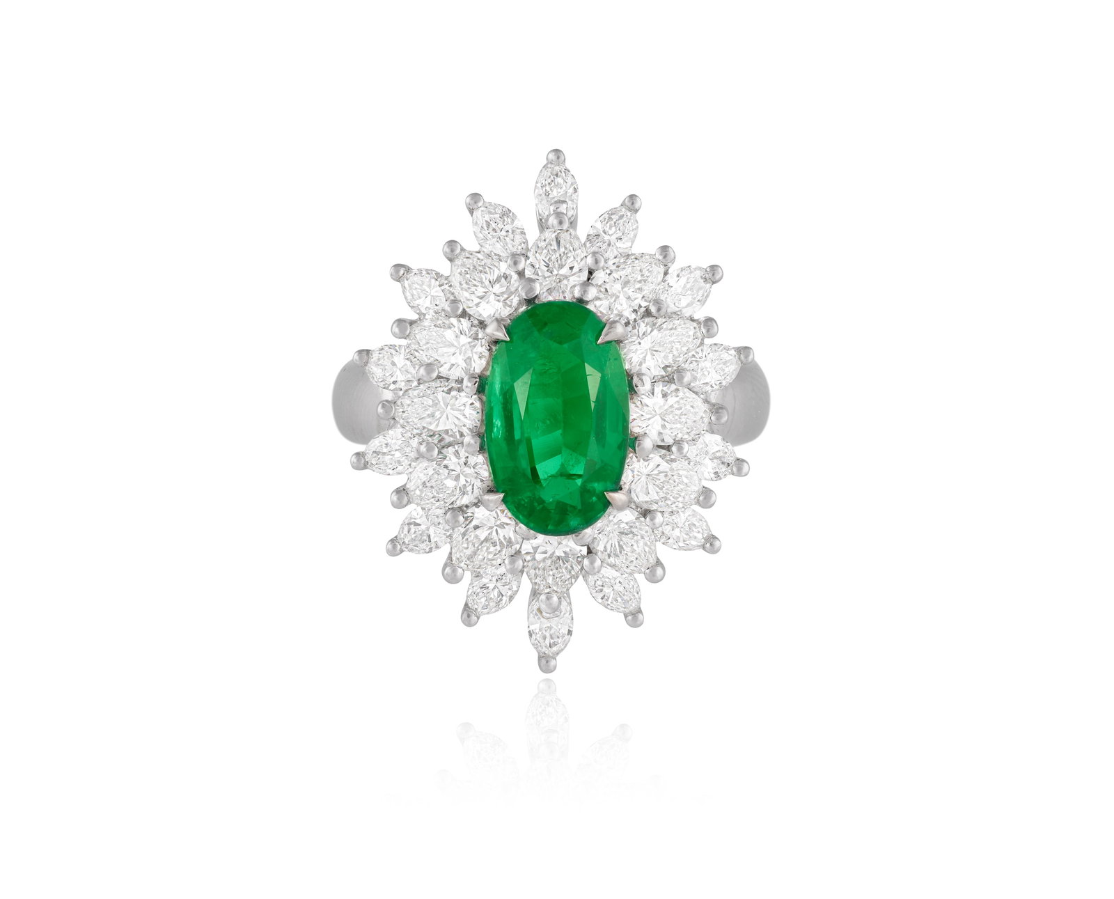 AN EMERALD AND DIAMOND CLUSTER RING Centring an oval-shaped emerald, within a double surround of (1 of 4)