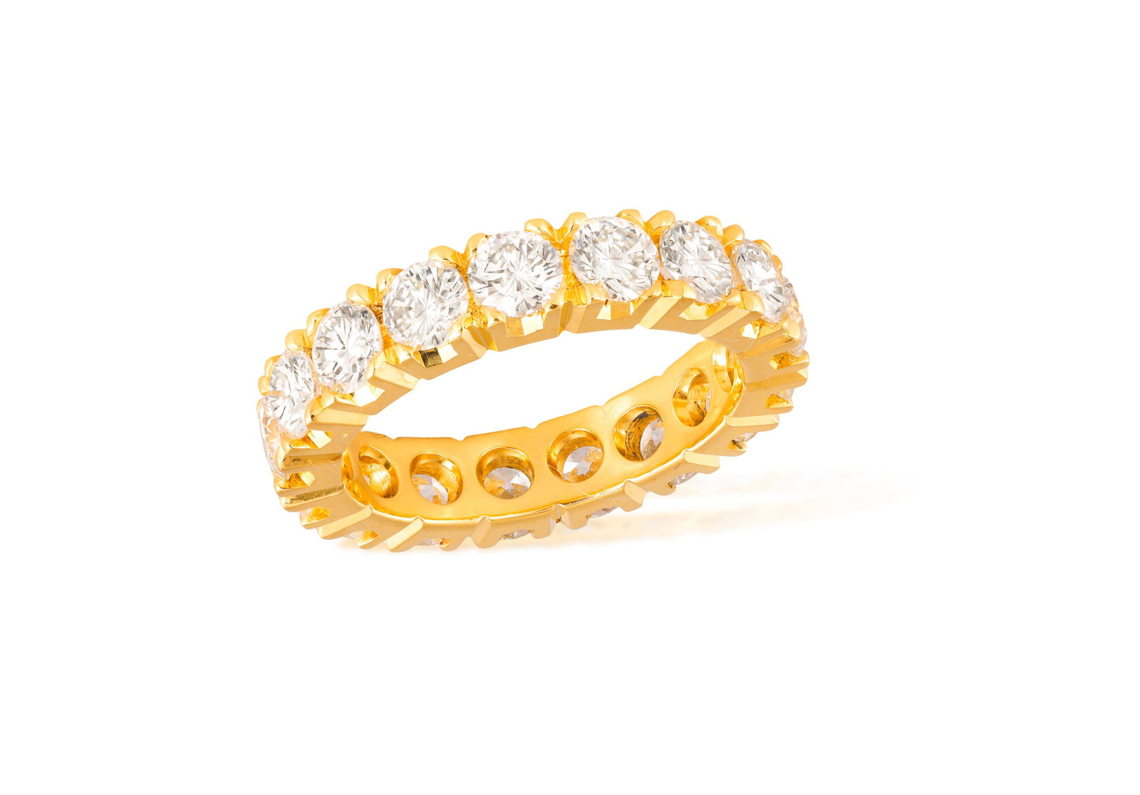 A DIAMOND ETERNITY RING Composed of a continuous row of brilliant-cut diamonds within claw-setting, (1 of 3)