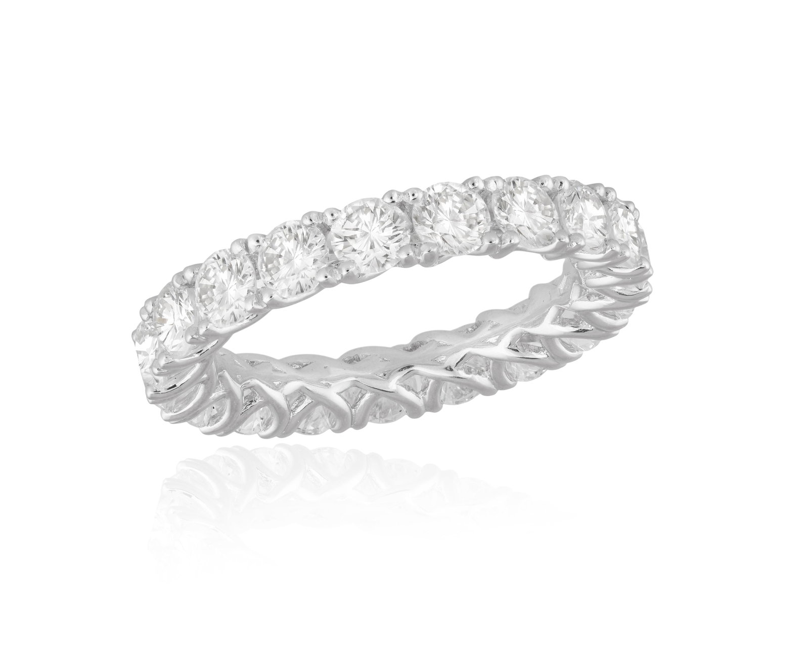 A DIAMOND ETERNITY RING Composed of a continuous row of brilliant-cut diamonds within claw-setting, (1 of 3)