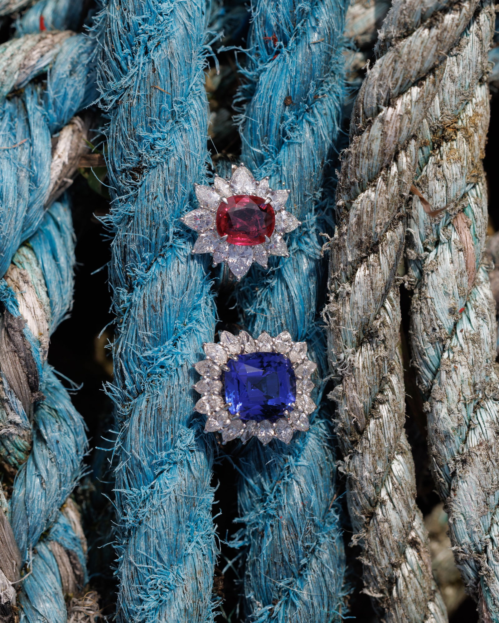 A RUBY AND DIAMOND CLUSTER RING Centring a cushion-shaped ruby weighing approximately 2.10cts, - 3