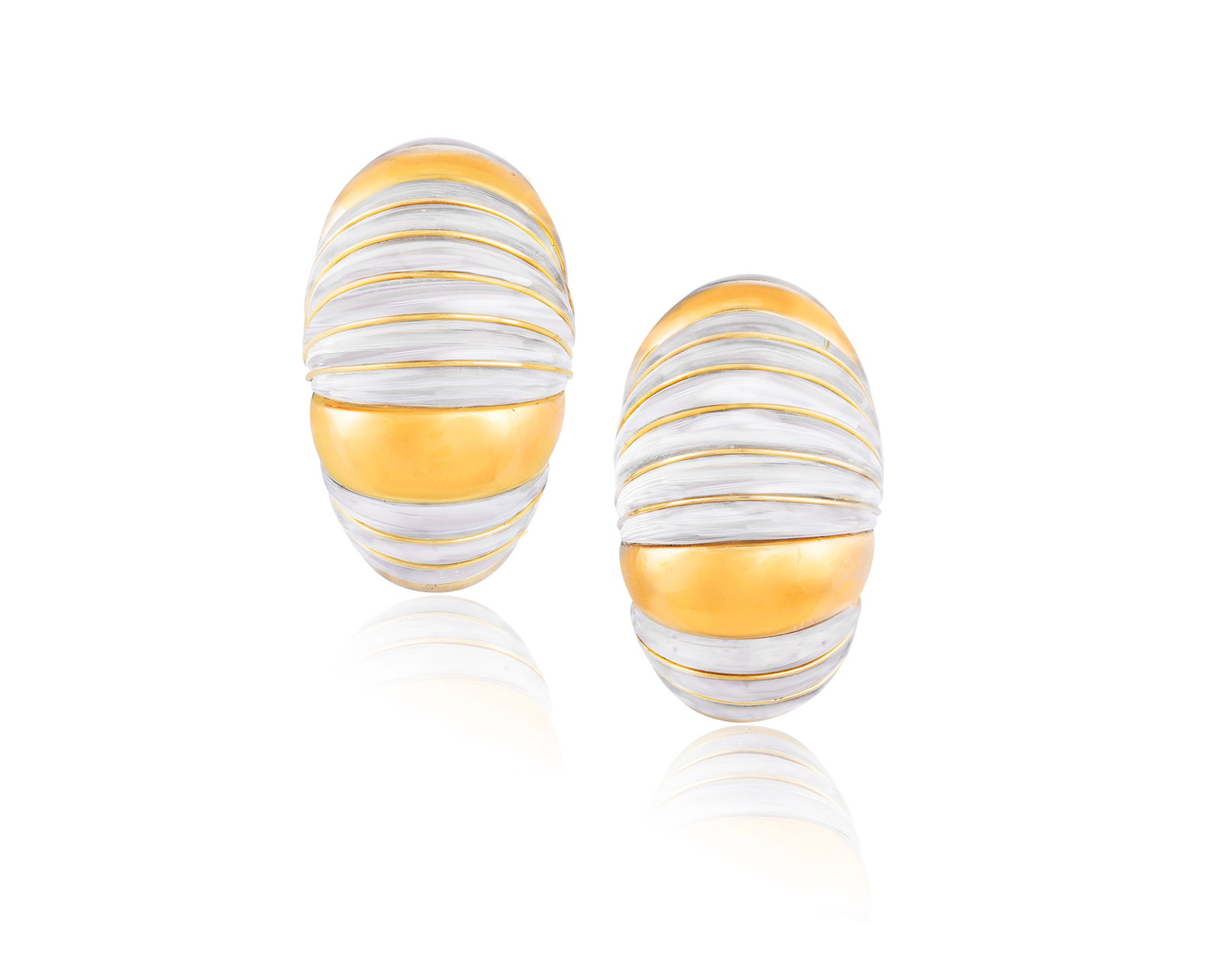 DAVID WEBB: A PAIR OF ROCK CRYSTAL AND GOLD EARCLIPS Each of bombé design, the fluted rock: DAVID WEBB: A PAIR OF ROCK CRYSTAL AND GOLD EARCLIPS Each of bombé design, the fluted rock crystal panels within polished gold ribbed borders, mounted in 18K gold, signed ©Webb ®, colla