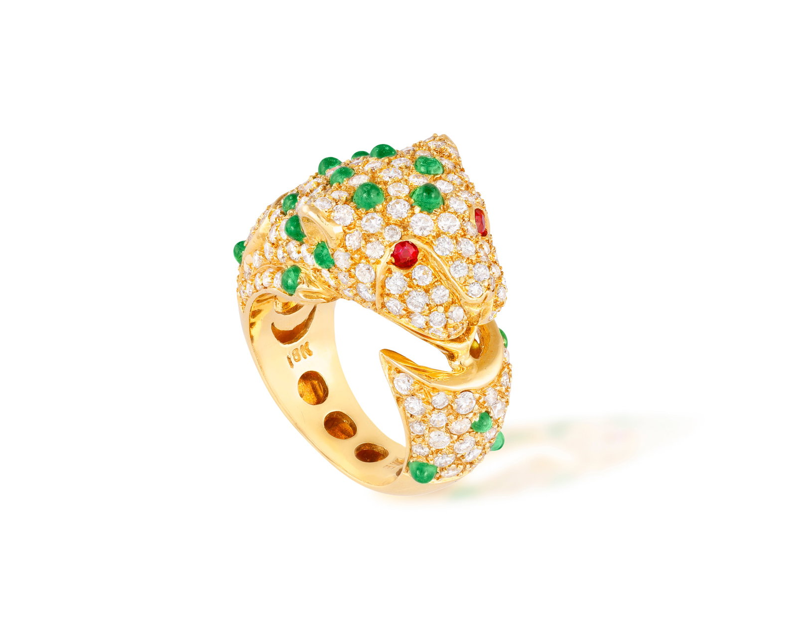 AN EMERALD AND DIAMOND PANTHER RING Pavé-set with brilliant-cut diamonds highlighted with: AN EMERALD AND DIAMOND PANTHER RING Pavé-set with brilliant-cut diamonds highlighted with circular emerald cabochon spots and circular-cut ruby eyes, mounted in 18K gold, ring size M