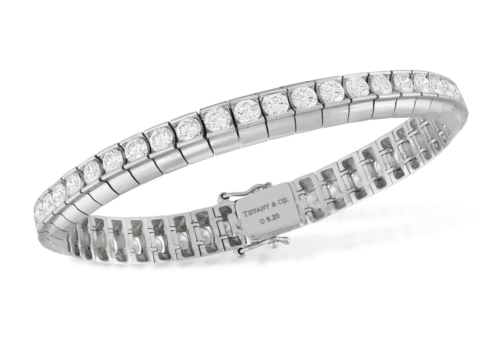 TIFFANY & CO.: A DIAMOND LINE BRACELET Set with a continuous line of brilliant-cut diamonds within: TIFFANY & CO.: A DIAMOND LINE BRACELET Set with a continuous line of brilliant-cut diamonds within channel-setting, mounted in 18K gold, weight stamped 6.20cts, signed ‘Tiffany & Co.’, len
