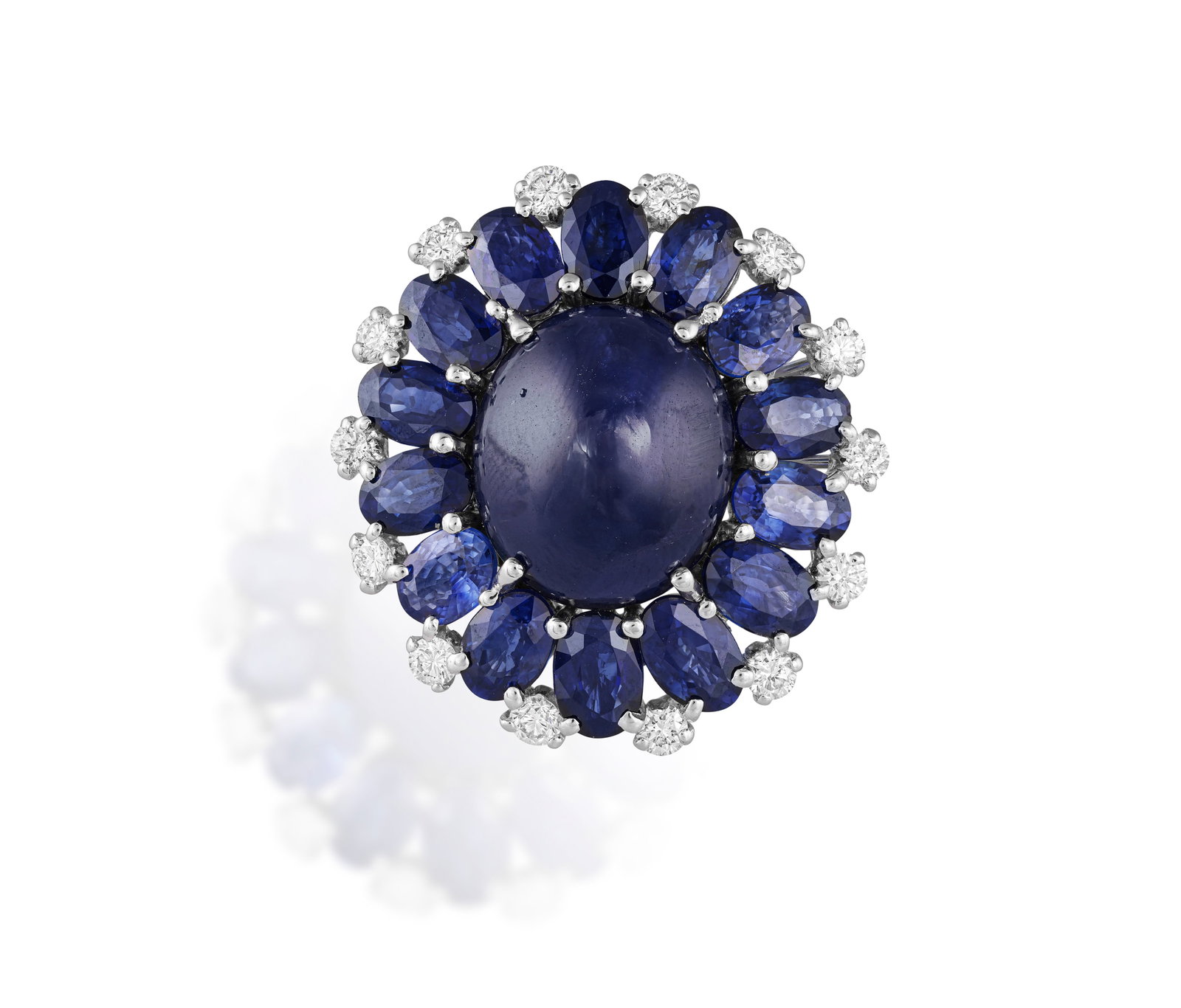 A SAPPHIRE AND DIAMOND DRESS RING The oval-shaped sapphire cabochon at the centre weighing: A SAPPHIRE AND DIAMOND DRESS RING The oval-shaped sapphire cabochon at the centre weighing approximately 14.50cts, within an oval-shaped sapphire surround accented with brilliant-cut diamonds, mounted