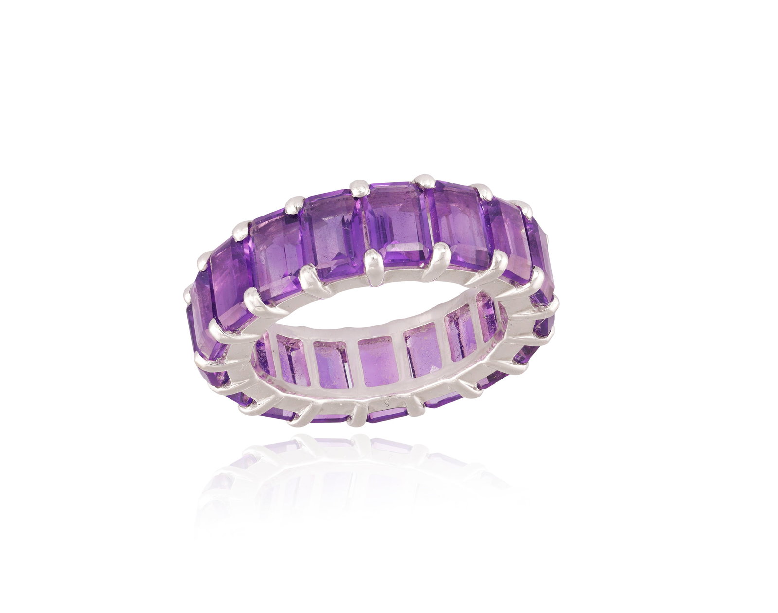 AN AMETHYST ETERNITY RING Composed of a continuous row of rectangular-cut amethysts within: AN AMETHYST ETERNITY RING Composed of a continuous row of rectangular-cut amethysts within claw-setting, mounted in 18K gold, amethysts approximately 11.50cts total, ring size M⅓
