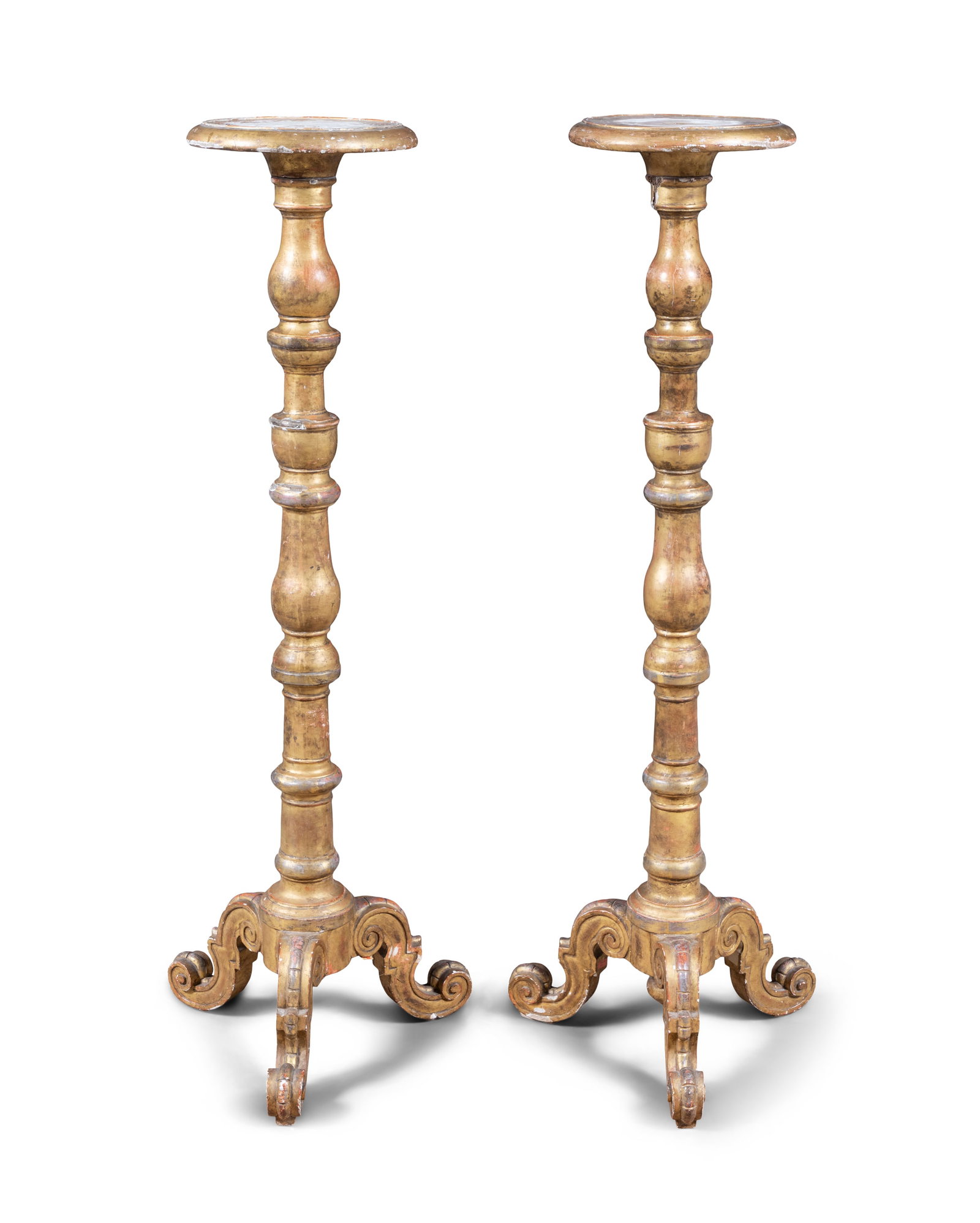 A PAIR OF GILTWOOD TORCHÈRES, LATE 19TH CENTURY each with a circular top on turned column: A PAIR OF GILTWOOD TORCHÈRES, LATE 19TH CENTURY each with a circular top on turned column supports and scrolled tripod feet, 148 cm high Provenance: The Barons Rossmore, Rossmore Castle, Co. Mona