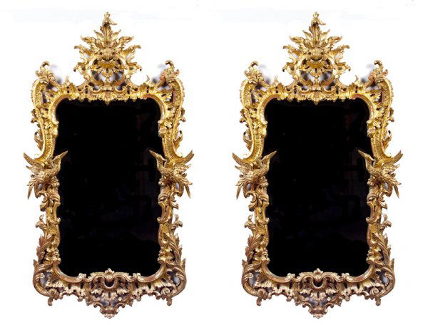 A fine pair of 19th Century George III style carve: A fine pair of 19th Century George III style carved giltwood wall mirrors, in the manner of Thomas Chippendale, the rectangular mirror plate surmounted by an acanthus embellished cartouche above a lea