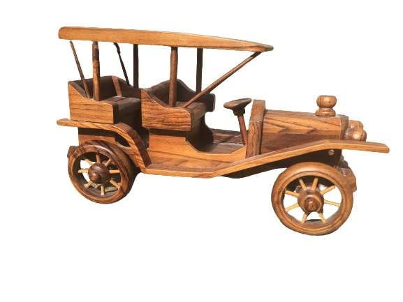 A small wood carved automobile: A small wood carved automobile! Great decorative object with many details.