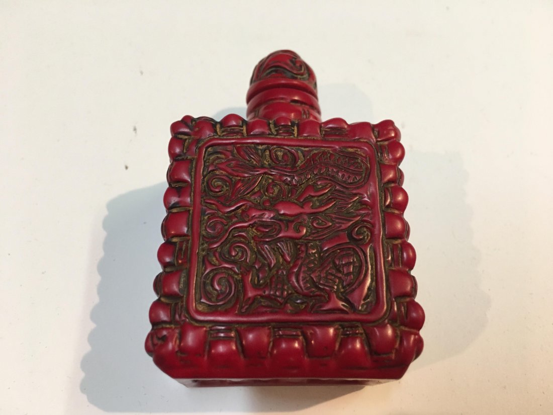 Chinese Hand carved old snuff bottle: A Chinese old coral hand carved snuff bottle with a cap. almost 3" by 2" inches.