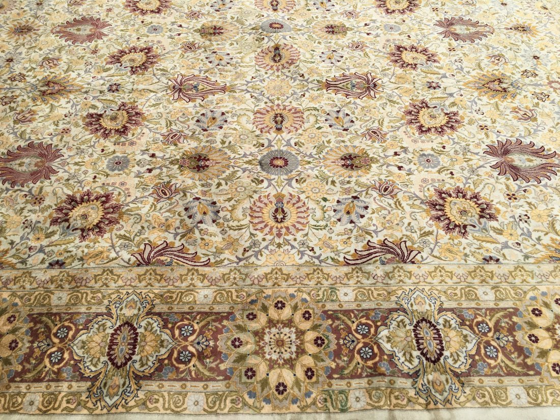A Pakistan Tabriz handwoven rug: A Pakistan Tabriz design handwoven rug measuring 9 ft 9 in by 13 ft 6 inches long.
