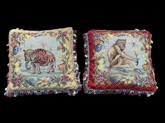 Pair of needlepoint Monkey & Elephant pillows: Pair of needlepoint Monkey & elephant tasseled pillows. each pillow measures 20" inches by 20" inches wide. Each pillow has a different subject.
