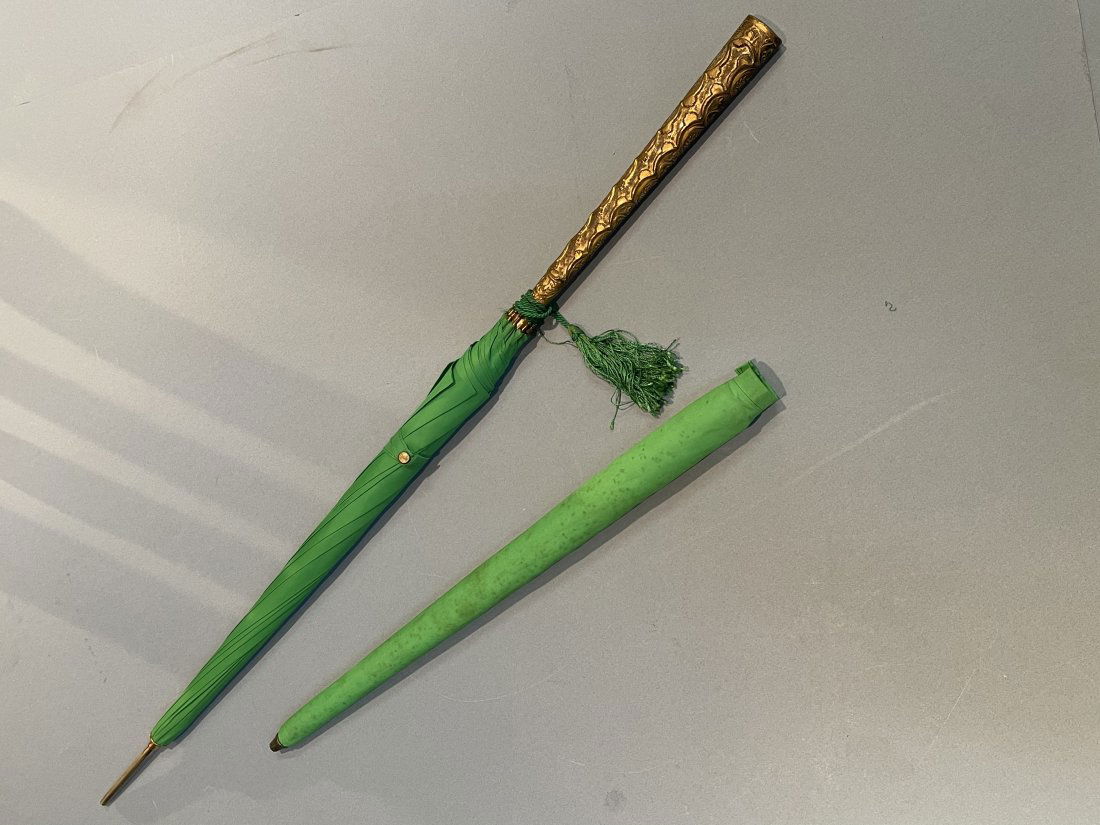 Antique Ladies Parasol Sun Umbrella: Antique Ladies Parasol , Sun Umbrella measuring 34 inches long top to bottom. With an elegant brass embossed handle and inscribed Kathleen on the BOTTOM Of the handle.