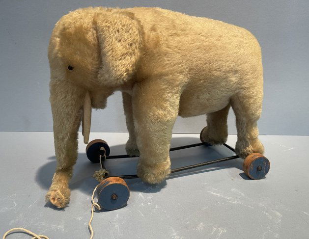 Antique Steiff Elephant on Wheels Pull Toy: Antique Steiff Elephant on Wheels Pull Toy on four wood wheels. Original Mohair, stuffing and eyes. One ear has the original Steiff metal button. Please see all the images posted.