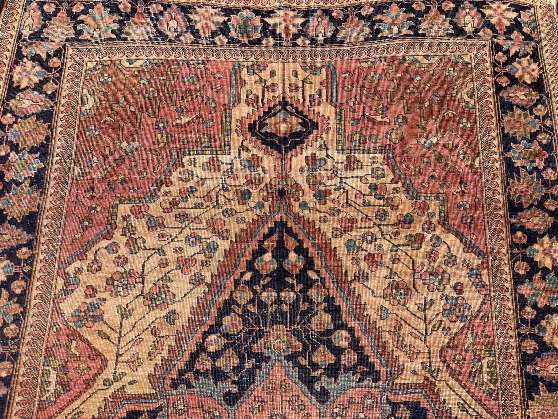 Antique Persian Sarouk rug: Antique Persian Sarouk hand woven rug measuring 4 feet 6 inches wide by 6 feet 7 inches long.