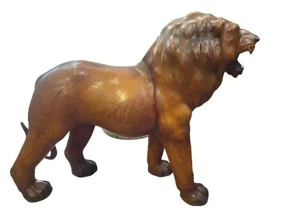 A large leather Lion: An old large leather Lion measuring 42 inches long and 30 inches tall. A unique leather decorative lion with a powerful presence.