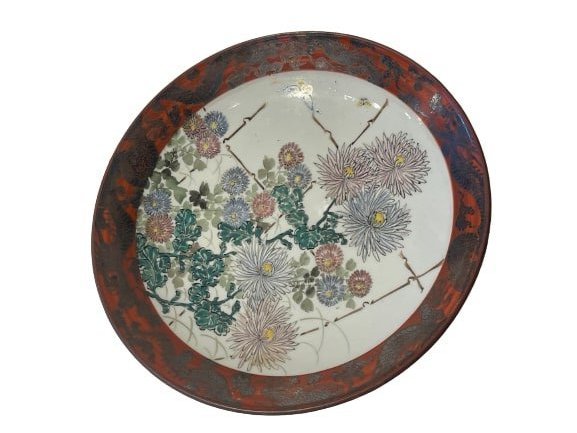 Asian old hand painted porcelain charger plate: An Asian old hand painted charger plate. A possibly Japanese plate stamped on the bottom by the makers name. A unique charger plate measuring 9 1/4 inches in diameter.