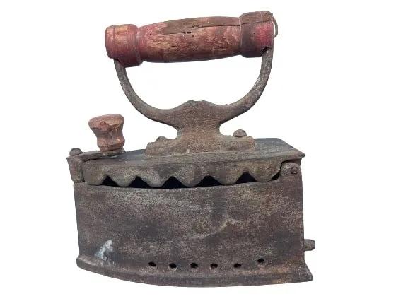 Antique Iron: Antique Iron with a wooden handle. Lift up top and charcoal compartment to heat up the iron. A unique decorative piece and ideal door stop.