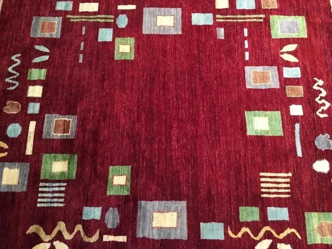 A handwoven Pakistan wool Rug: A handwoven Pakistan contemporary Chobi wool rug measuring 5 ft 3 inches by 7 feet long.